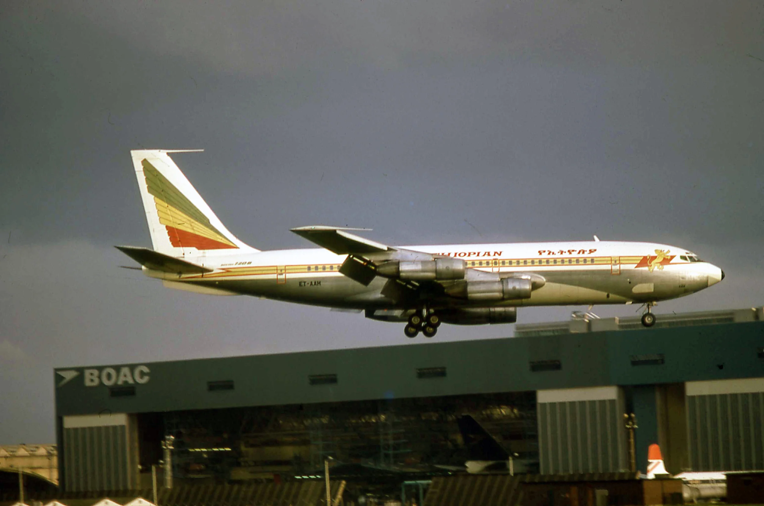 Ethiopian Airlines Boeing 720 ET-AAH landing at Heathrow in September 1974. With a BOAC 747 classic where else but in the BOAC hangars at the rear and the “training Comet” outside…nostalgia at its best?