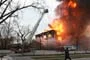 Ladder fully extended above raging fire