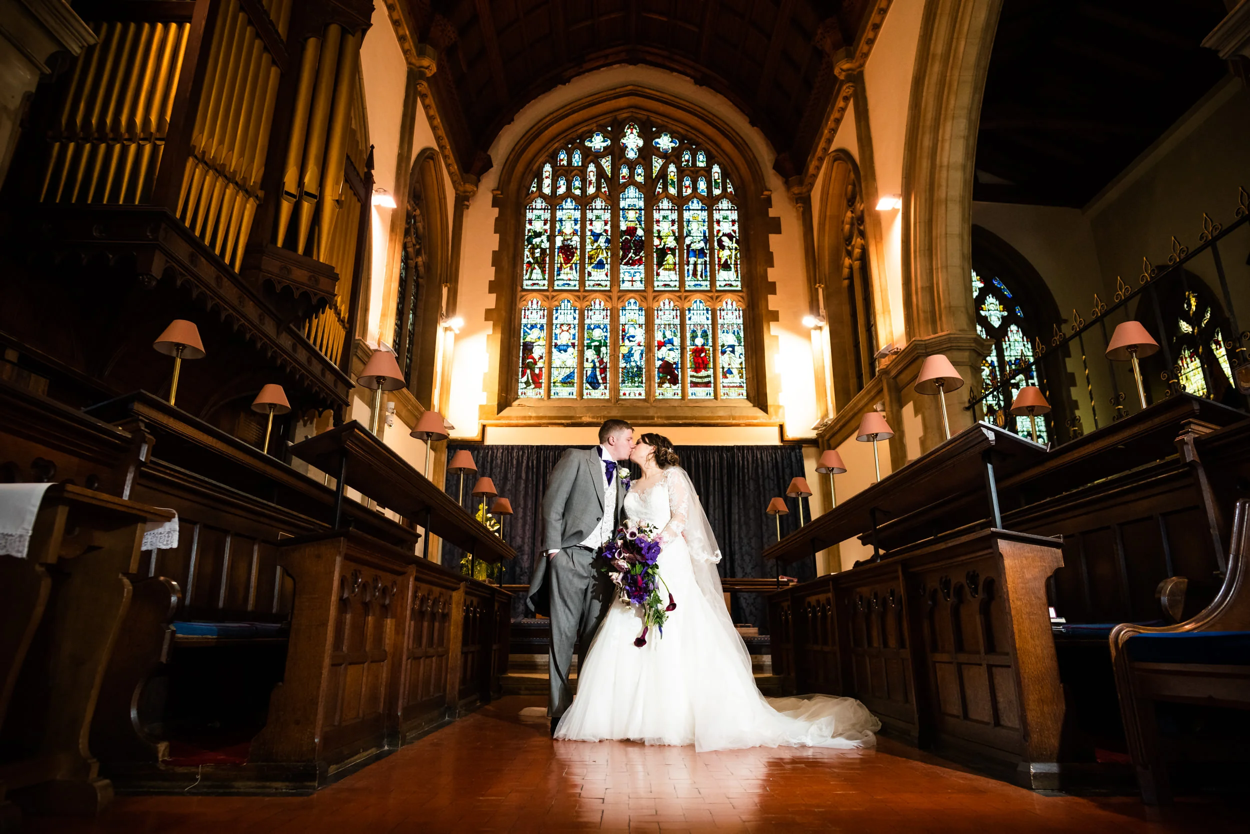 Newly wed couple kissing at the front of St Mary’s Church, Stourbridge