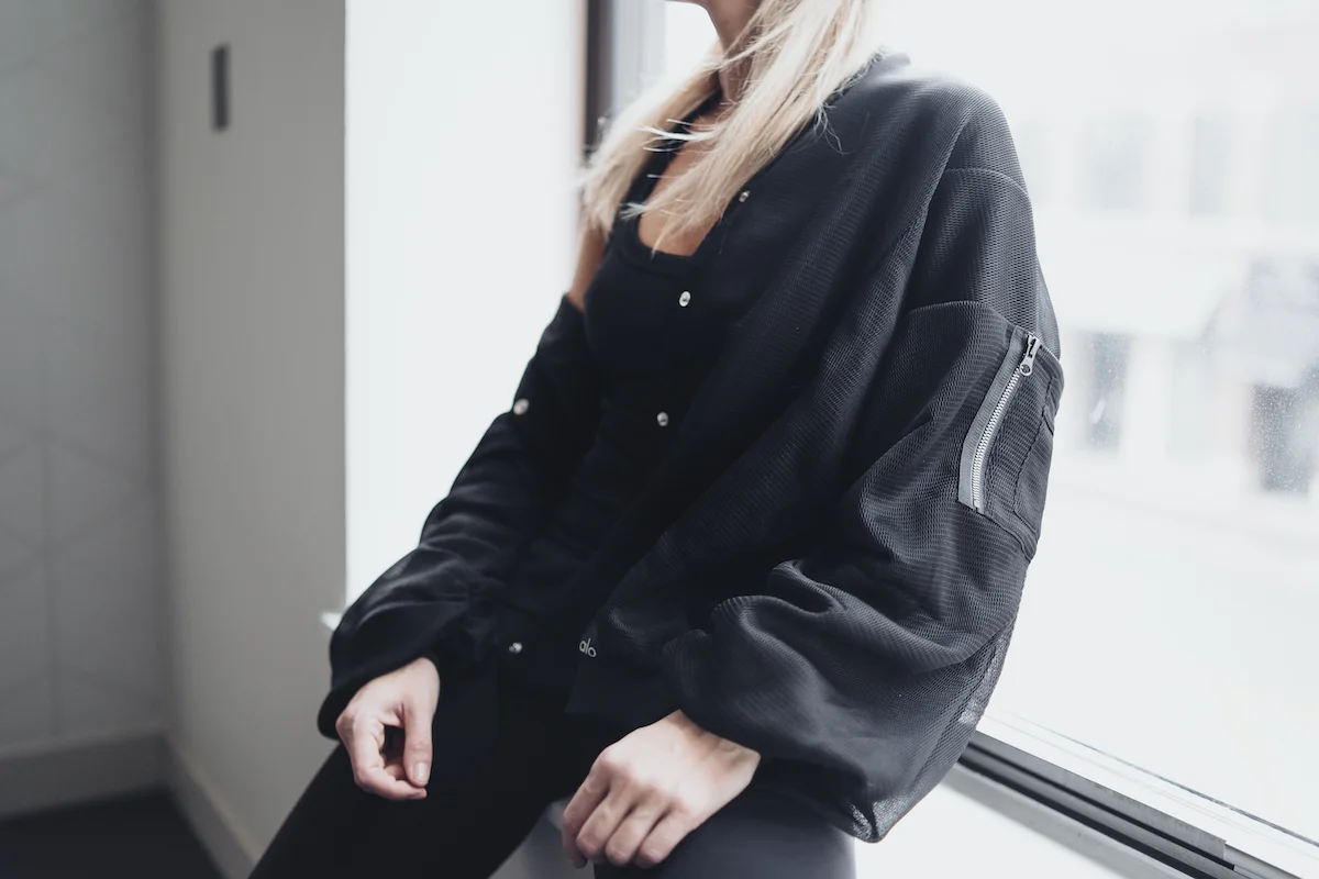 Monika Dixon of Monika Dixon Public Relations is wearing leggings, a tank top and jacket from Alo Yoga and Nike sneakers.