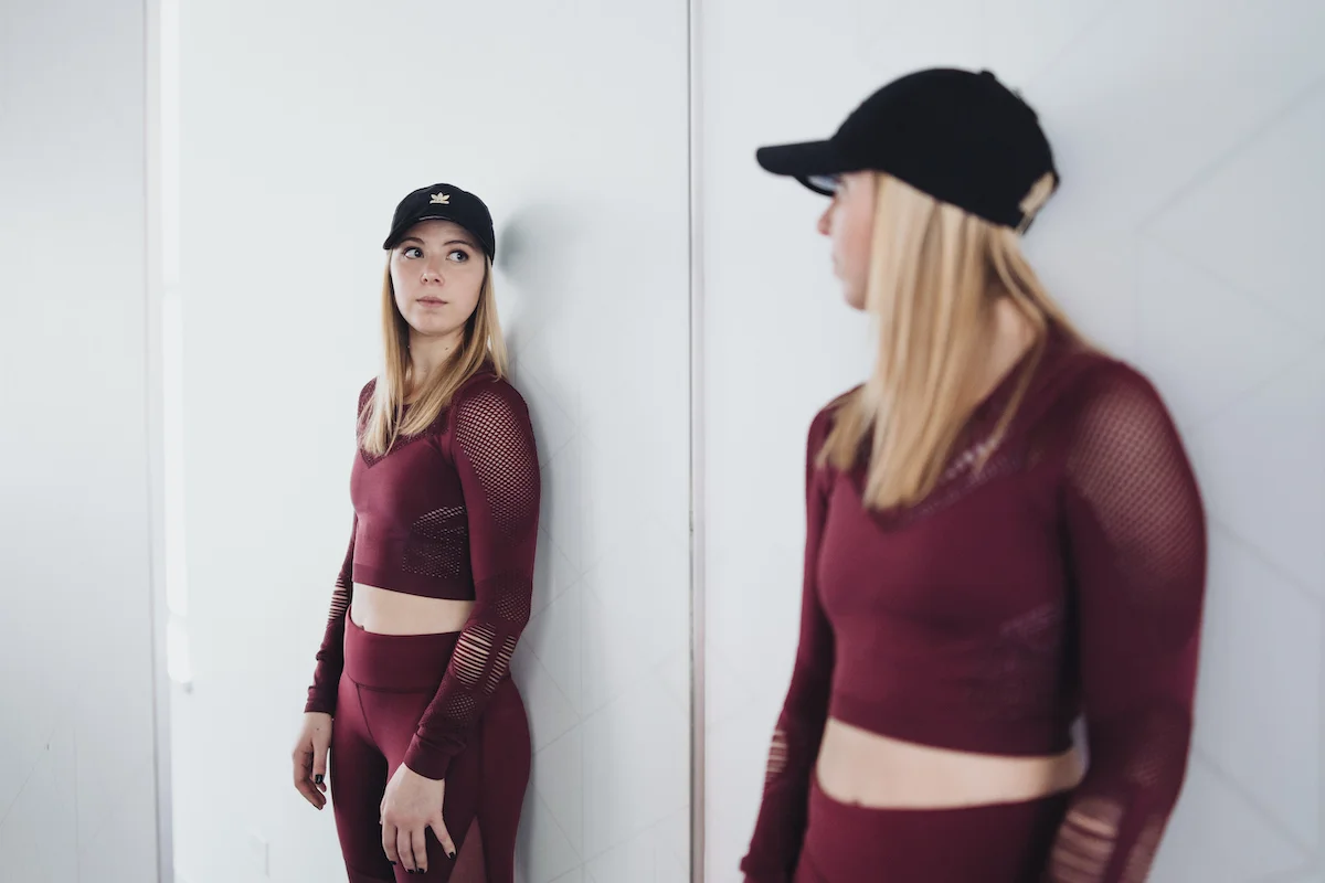 Abby Baum of Monika Dixon Public Relations is wearing a two piece set from Alo Yoga as well as hat and sneakers from Adidas.