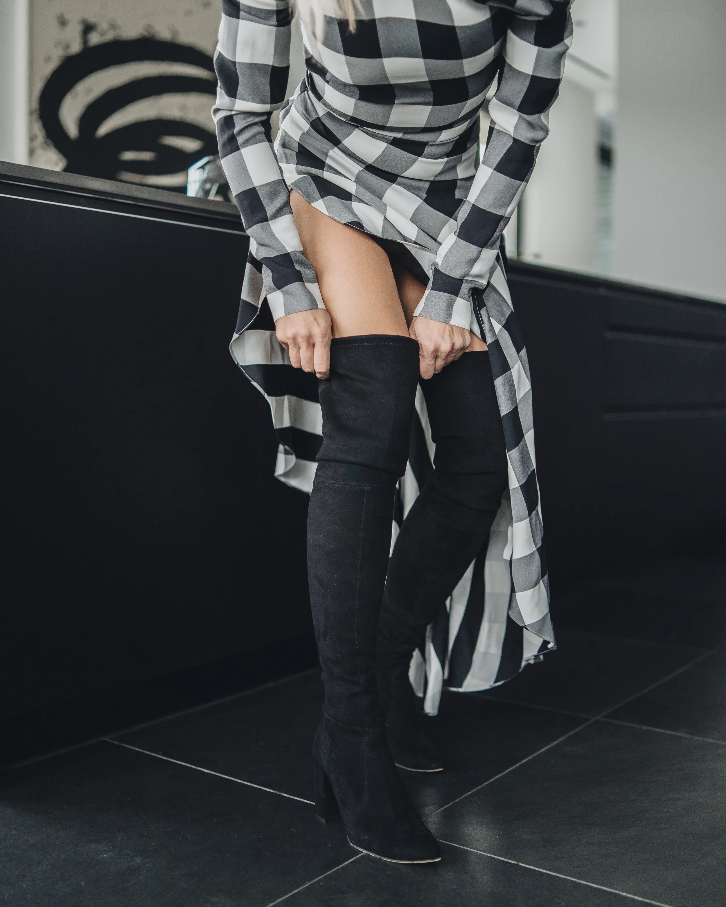 Monika Dixon of Monika Dixon Public Relations is wearing a Monse checkered dress and over-the-knee boots Stuart Weitzman Boots.