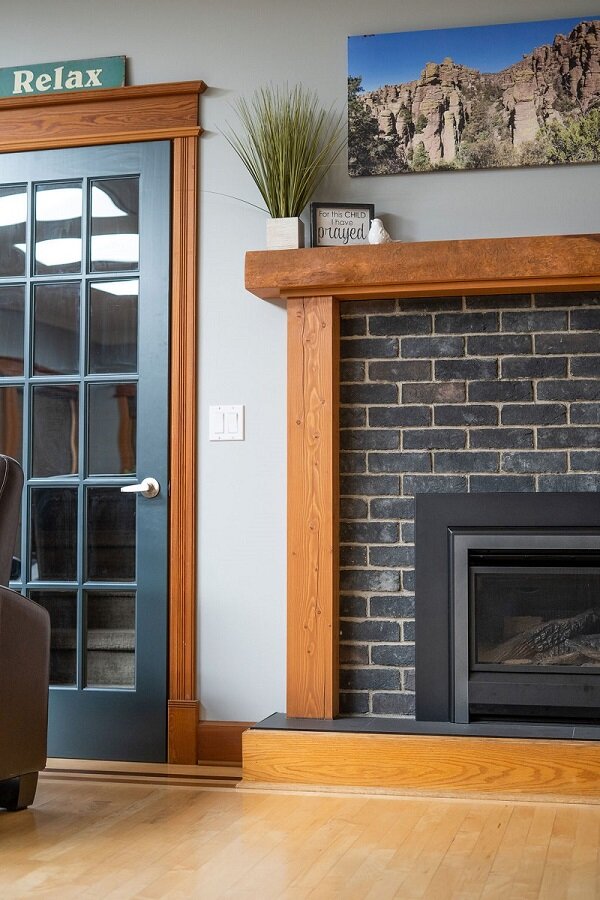 interior-designs-by-adrienne-cranbrook-bc-brick-veneer-eldorado-stone-wood-trims-painted door-fir-mantle-fireplace