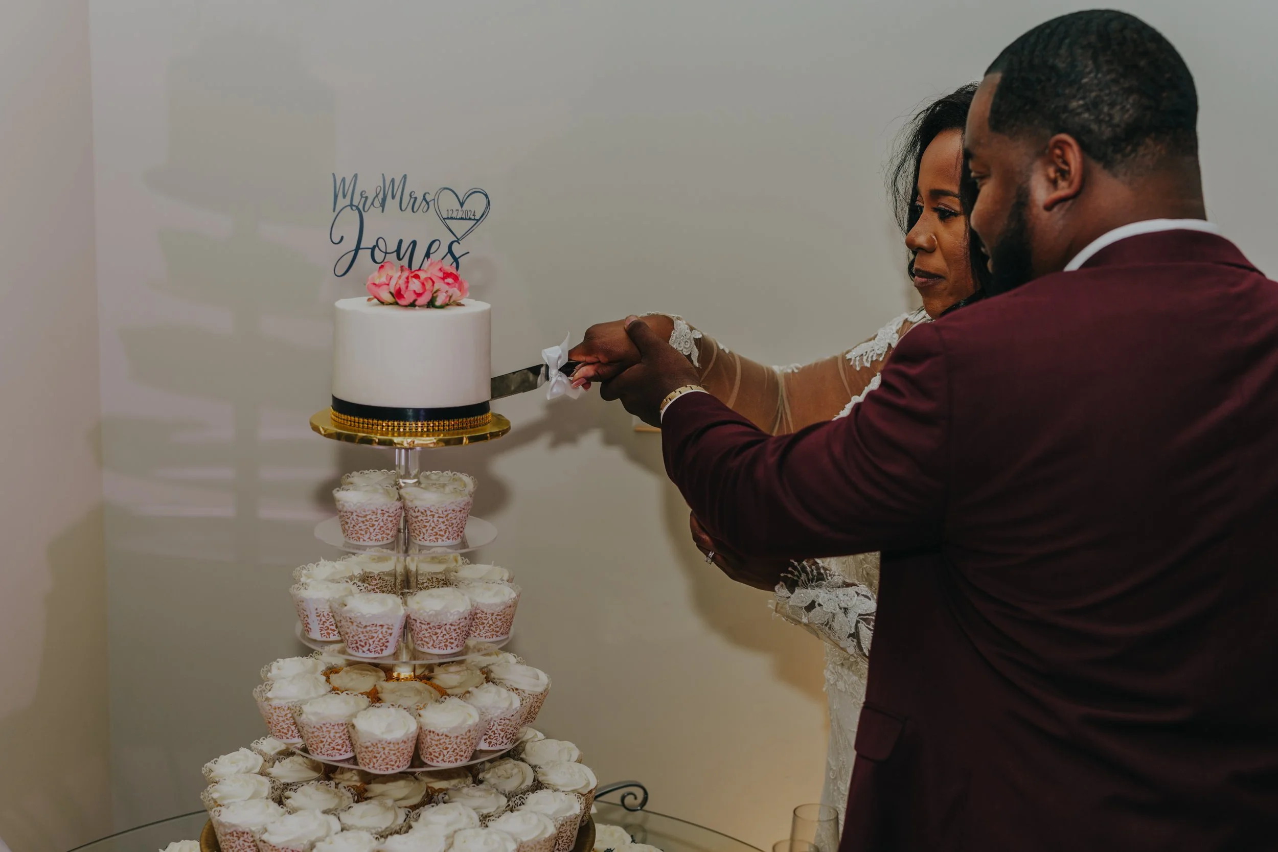 Couple cutting a wedding cake at their wedding reception.