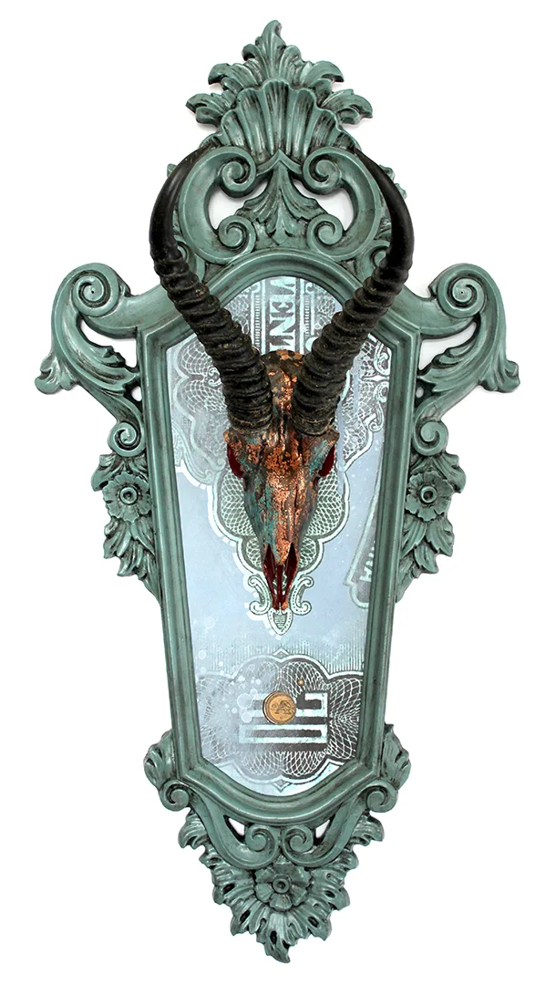 Title: DESTINY This is the latest piece in the series of a new direction that Anthony is artistically heading. He is working on a unique fusion of painting, drawing and re-purposed objects. This piece features an authentic springbok skull that has been hand painted and copper leafed, mounted on a hand painted acrylic/mixed media background, and framed in a hand painted vintage frame. The skulls that he acquires come from humane and environmentally responsible means. Adding to the flair, is the custom made wax stamp signature you will find on each painting. Each wax stamp has it's own unique design that is specific to the year the piece was created. This piece has been professionally framed and mounted with a dust cover and installed hanging hardware. 17.5” W X 34” H X 10” D SOLD