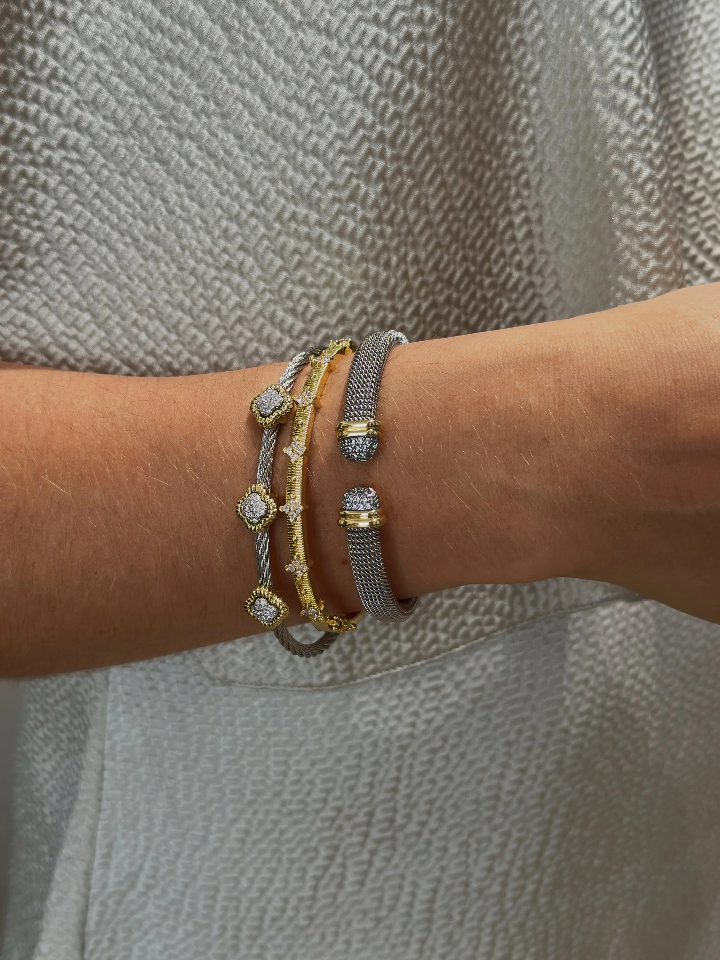 A little brilliance, thoughtfully layered. 

Worn alone or stacked together, these gold-plated bangles bring just enough light to a look. A special touch that shows through in everyday elegance.