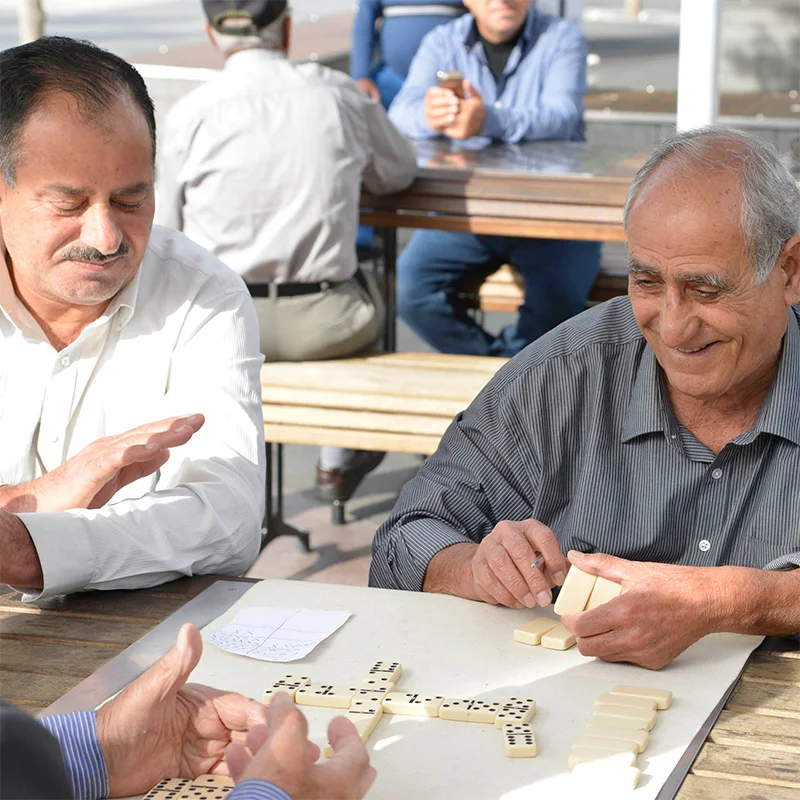 Three men playing dominoes