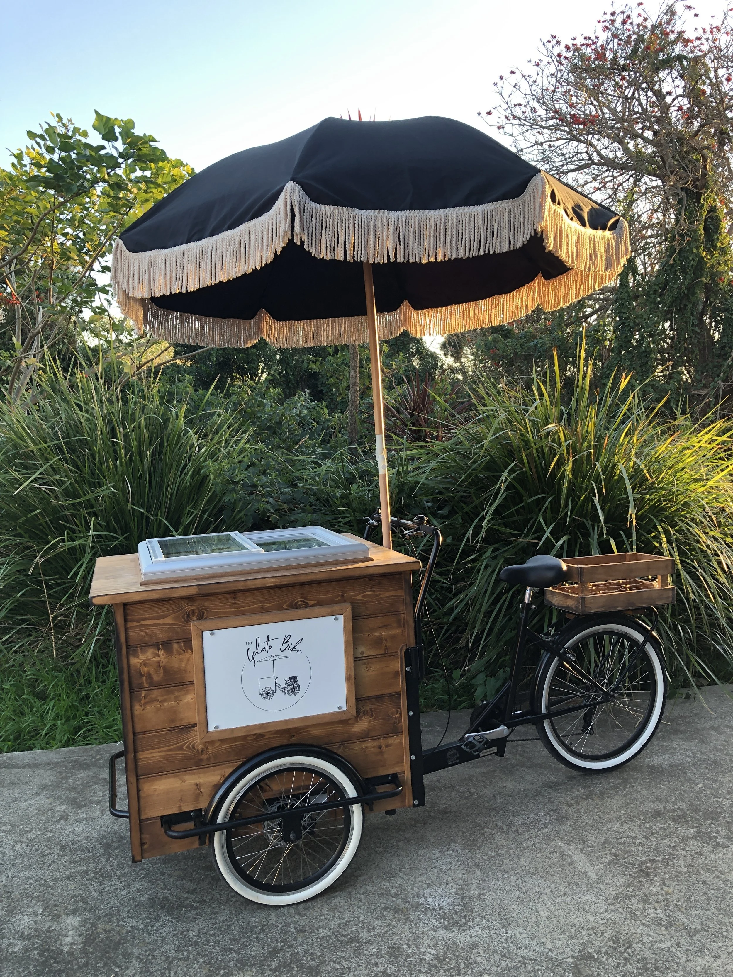 Timber gelato bike with black umbrella set up for stylish outdoor events