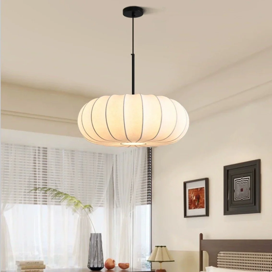 Wabi sabi pumpkin pendant lamp over bed in bright Japandi bedroom, white walls, Singapore condo
