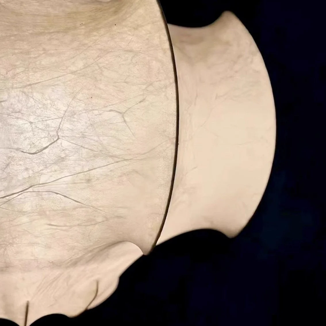 Close-up of synthetic silk panels and scalloped edge on wabi sabi bat pendant lamp