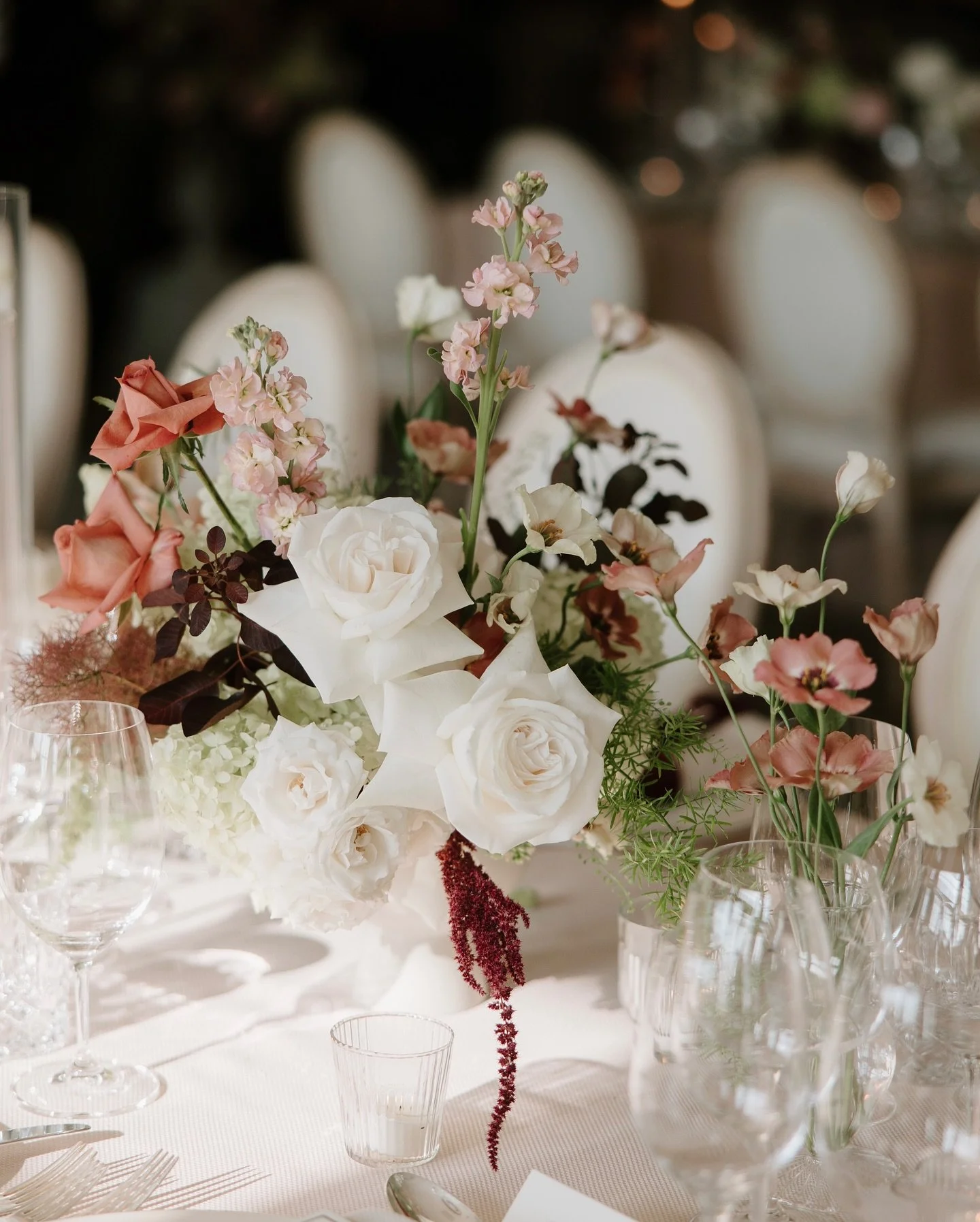 Stills from the wedding reception table flower details for Georgina and Thomas at Chewton Glen. This was a summer wedding but I&rsquo;m also thinking that the rich velvety pinks, crimson claret and candle glow would look beautiful in a winter wedding
