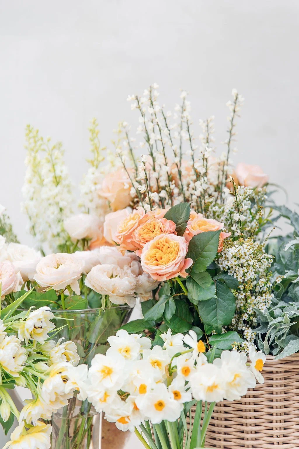 Beautiful bouquets of fresh flowers sit in various baskets awaiting delivery.