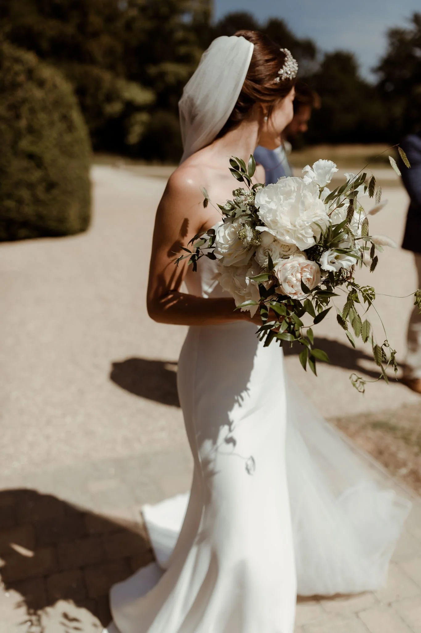 bride holding cream and white bouquet