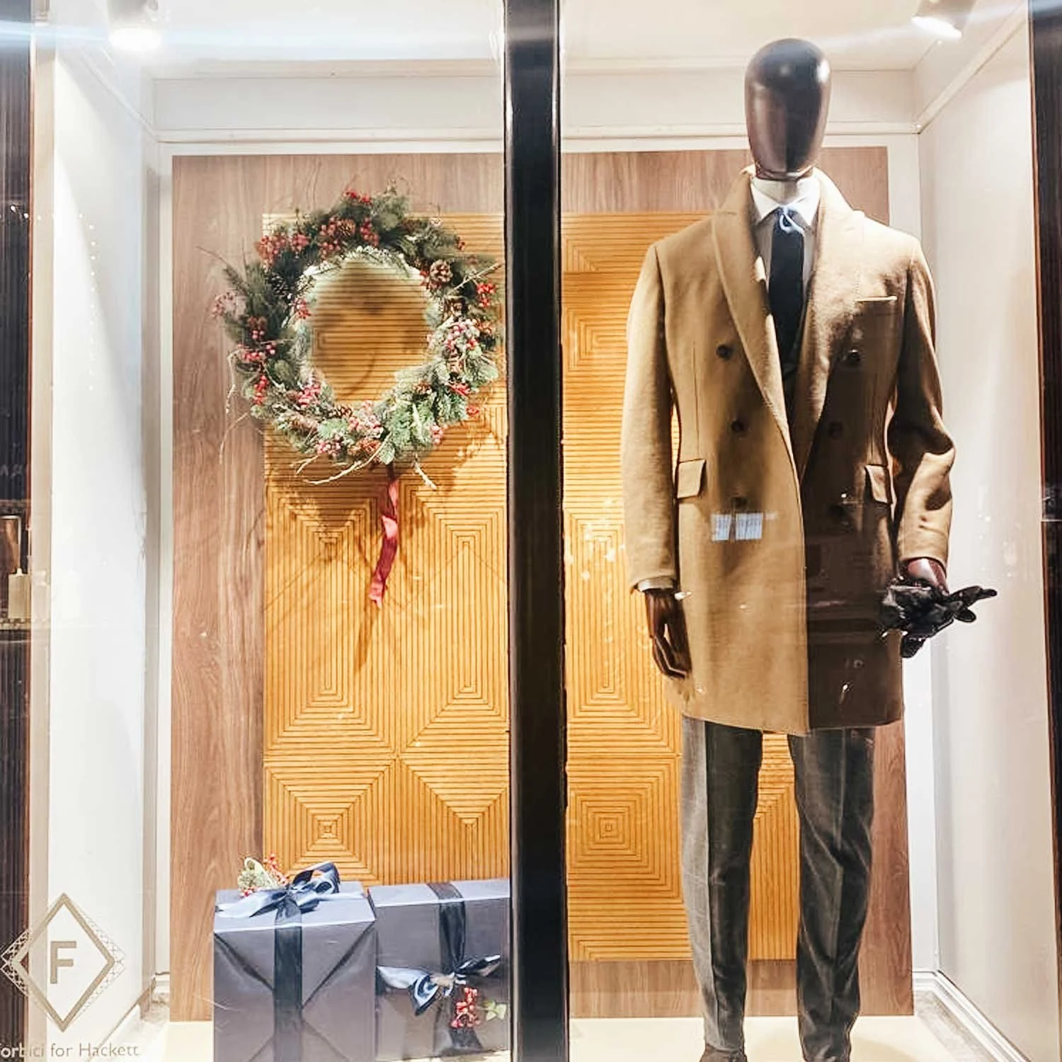 Festive botanical window styling with illuminated Christmas wreaths