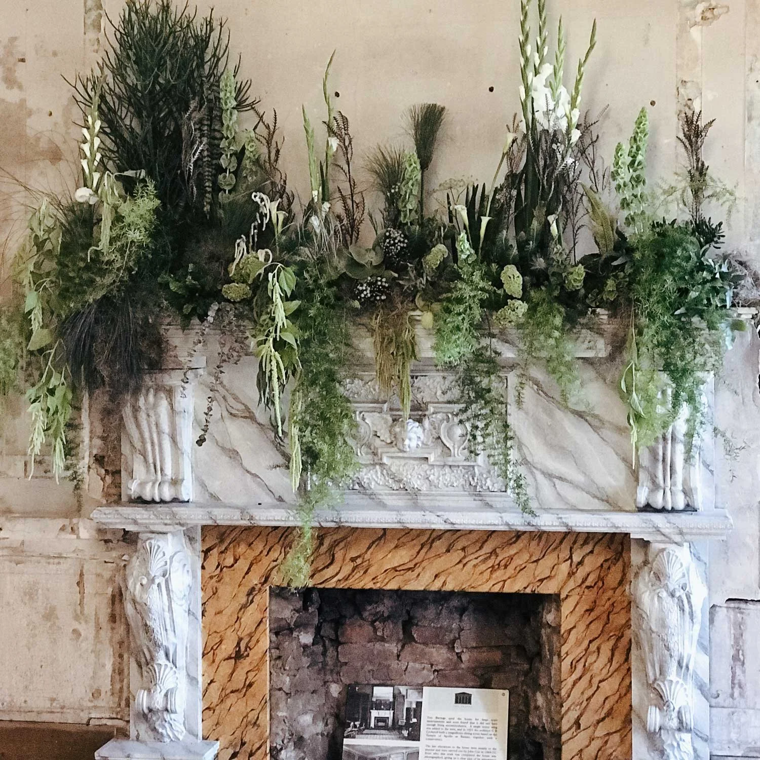 Underwater-inspired floral installation with ferns, cala lilies, moss and grasses