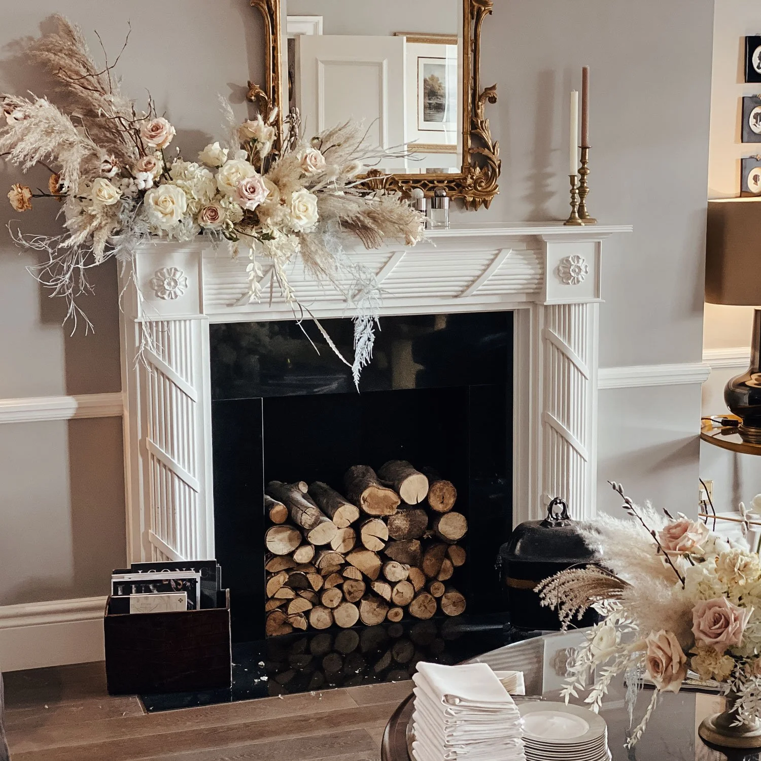 A fireplace styled with flowers for Molton Brown influencer event