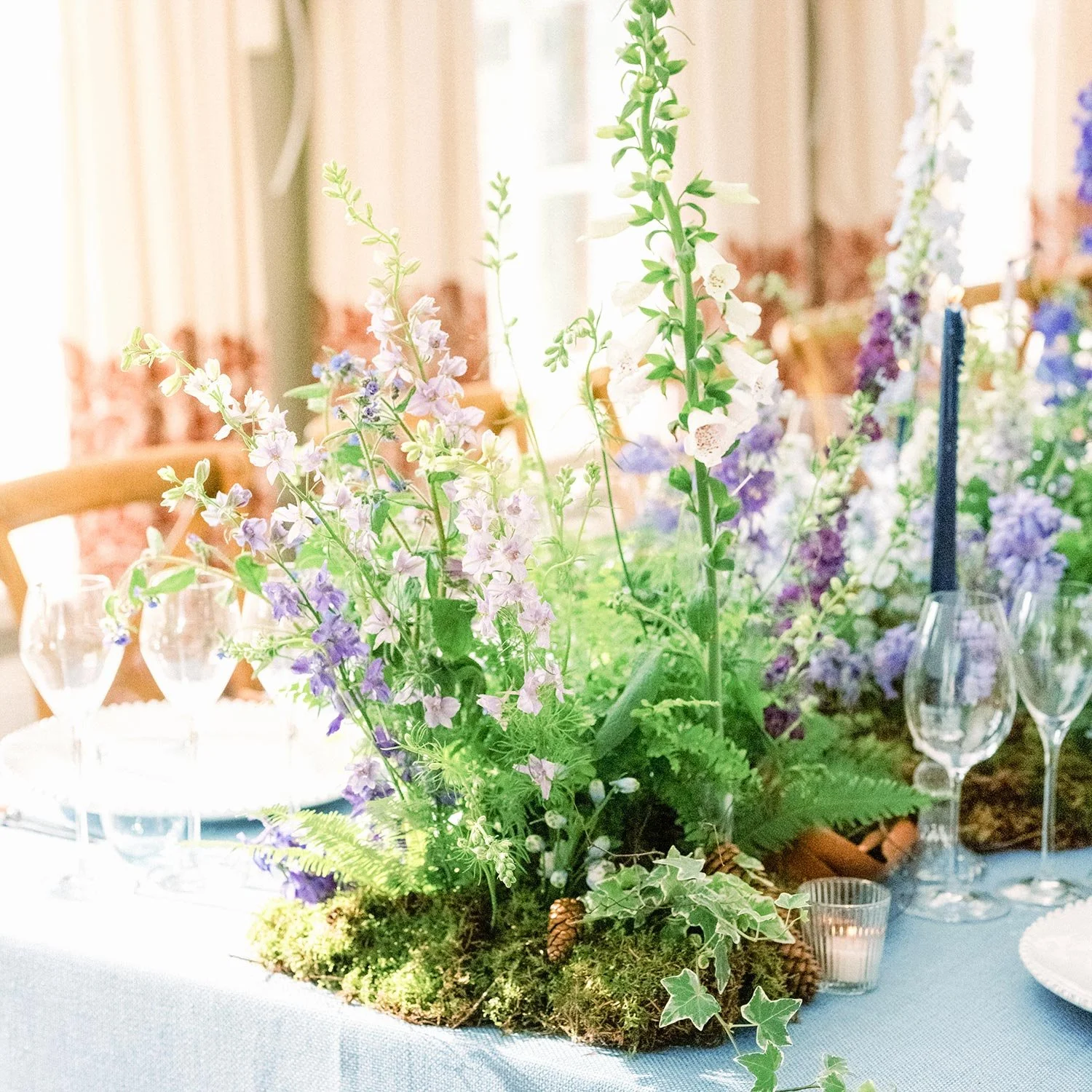 Bluebell woodland-inspired floral styling in the Summer House at Chewton Glen
