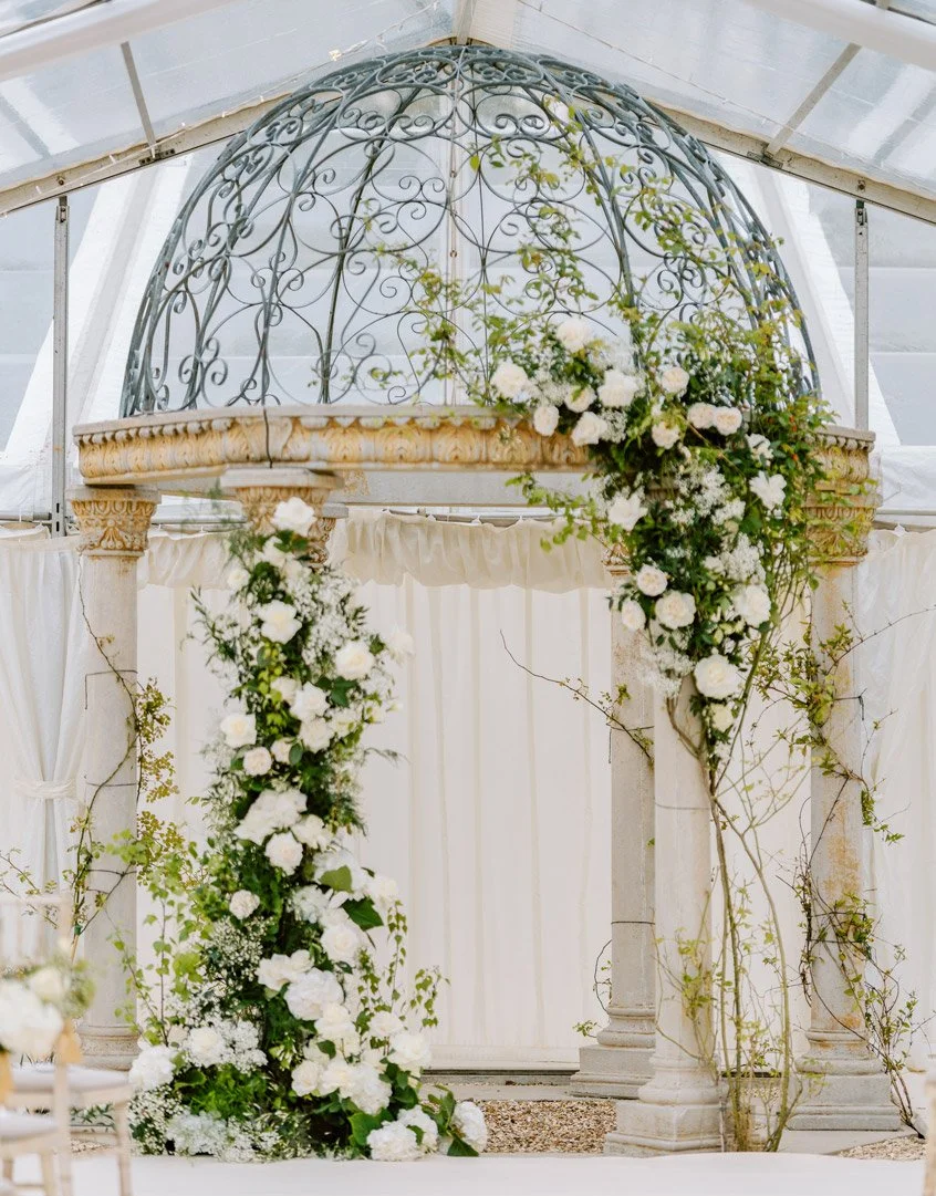 An outdoor wedding pagoda decorated with gorgeous wedding flowers.