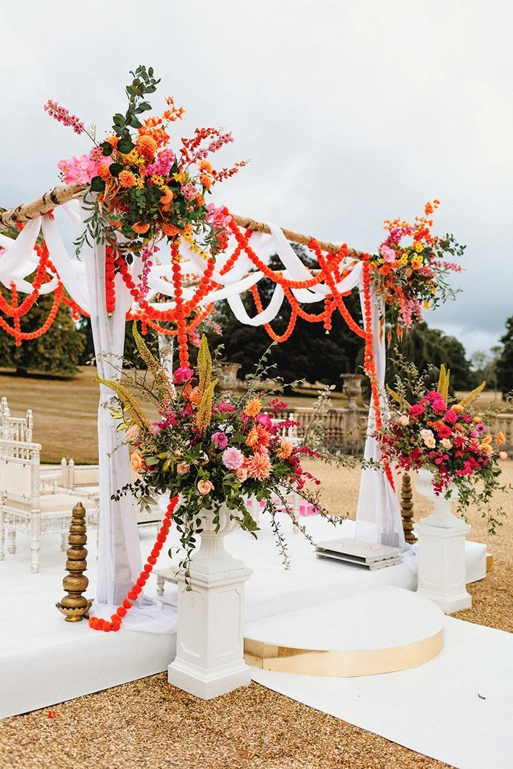 An outdoor wedding pagoda decorated with gorgeous wedding flowers.