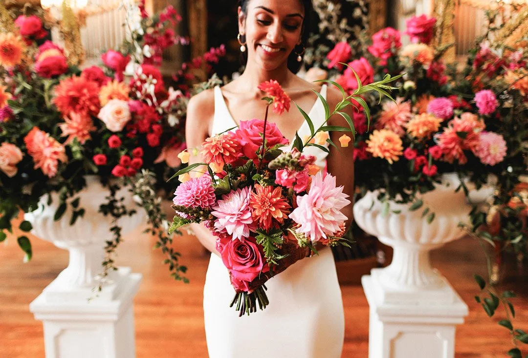 A Bride holds a stunning bouquet of fresh wedding flowers.