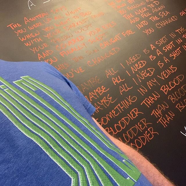 Wilco t-shirt day again. This time in front of the lyric wall. &ldquo;A Shot in the Arm&rdquo; this week.  #wilco #jefftweedy #lighthousewineshop #coolwineshop #turnupthewilco #stjosephmichigan