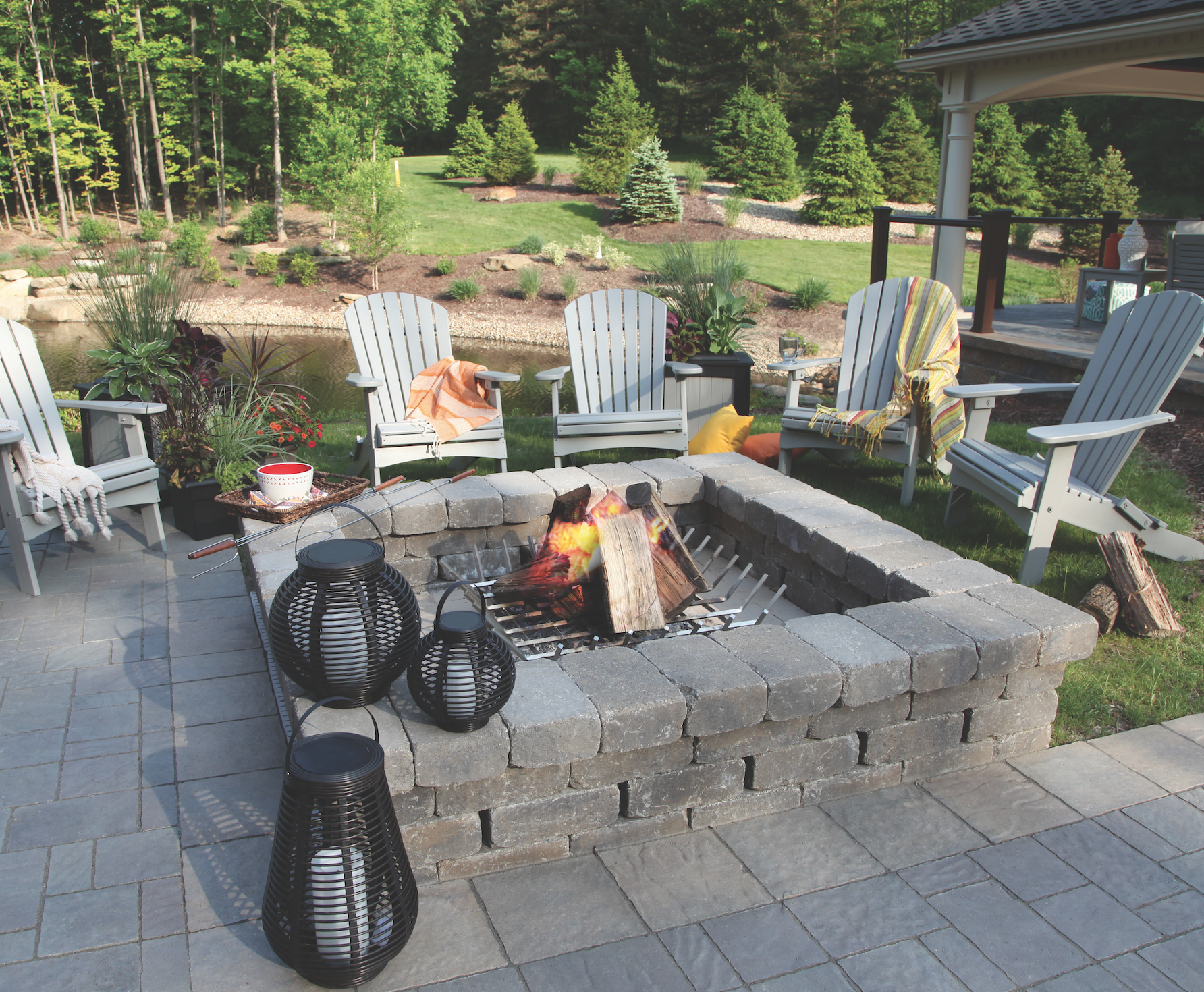  Adriondack chairs in light gray around square fire pit. 