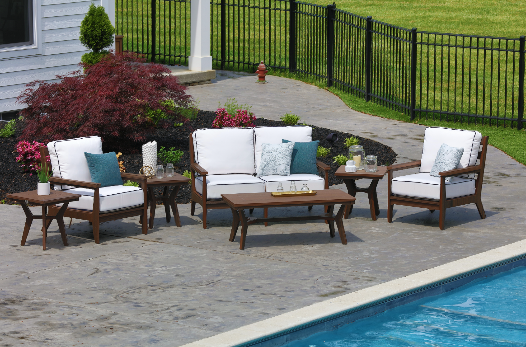  Mayhew Loveseat and Club Chairs in Brazilian Walnut. Cushions in Canvas Natural with Canvas Navy cording. Pillows in Calm Laurel and Nurture Laurel. Mayhew Rectangular Coffee Table and Square End Tables in Brazilian Walnut. 