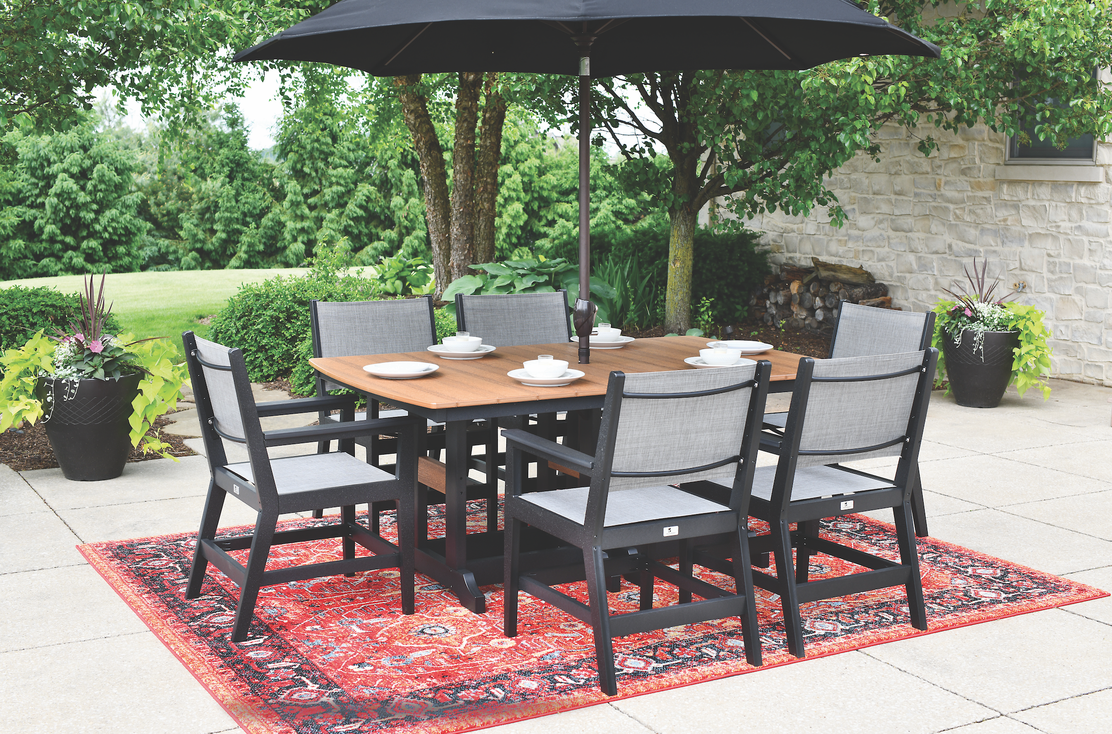  Mayhew sling dining arm chairs in black. Sling in augustine pewter. Garden classic 44” x 72” rectangular table (dining height) in antique mahogany on black. 