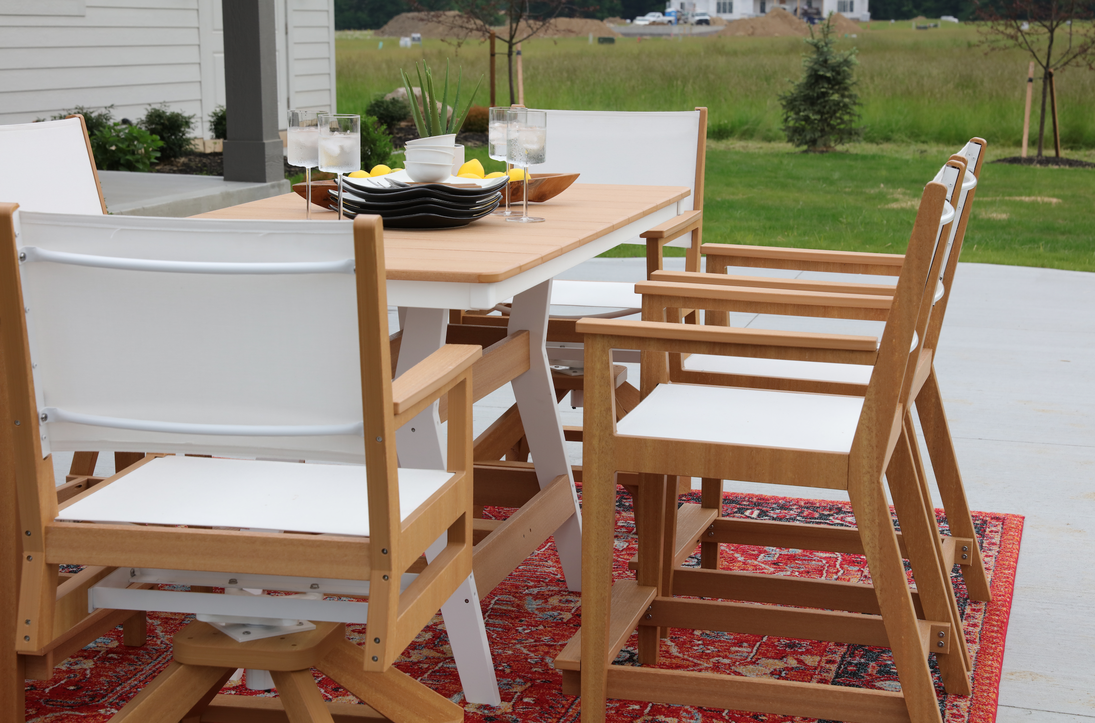  Harbor Counter Table in Natural Teak on White. Mayhew Counter Chair and Swivel Counter Chair in Teak with Sailing Seat Sling 