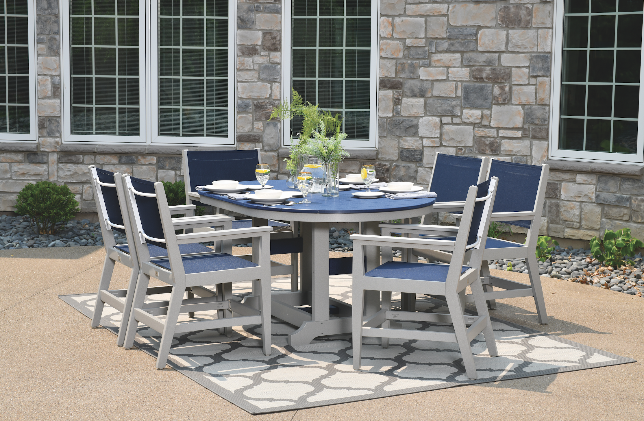 Garden class 44” x 64” oblong table (dining height) in navy blue on light gray with mayhew sling dining arm chairs in light gray. Sling in logan ocean. 