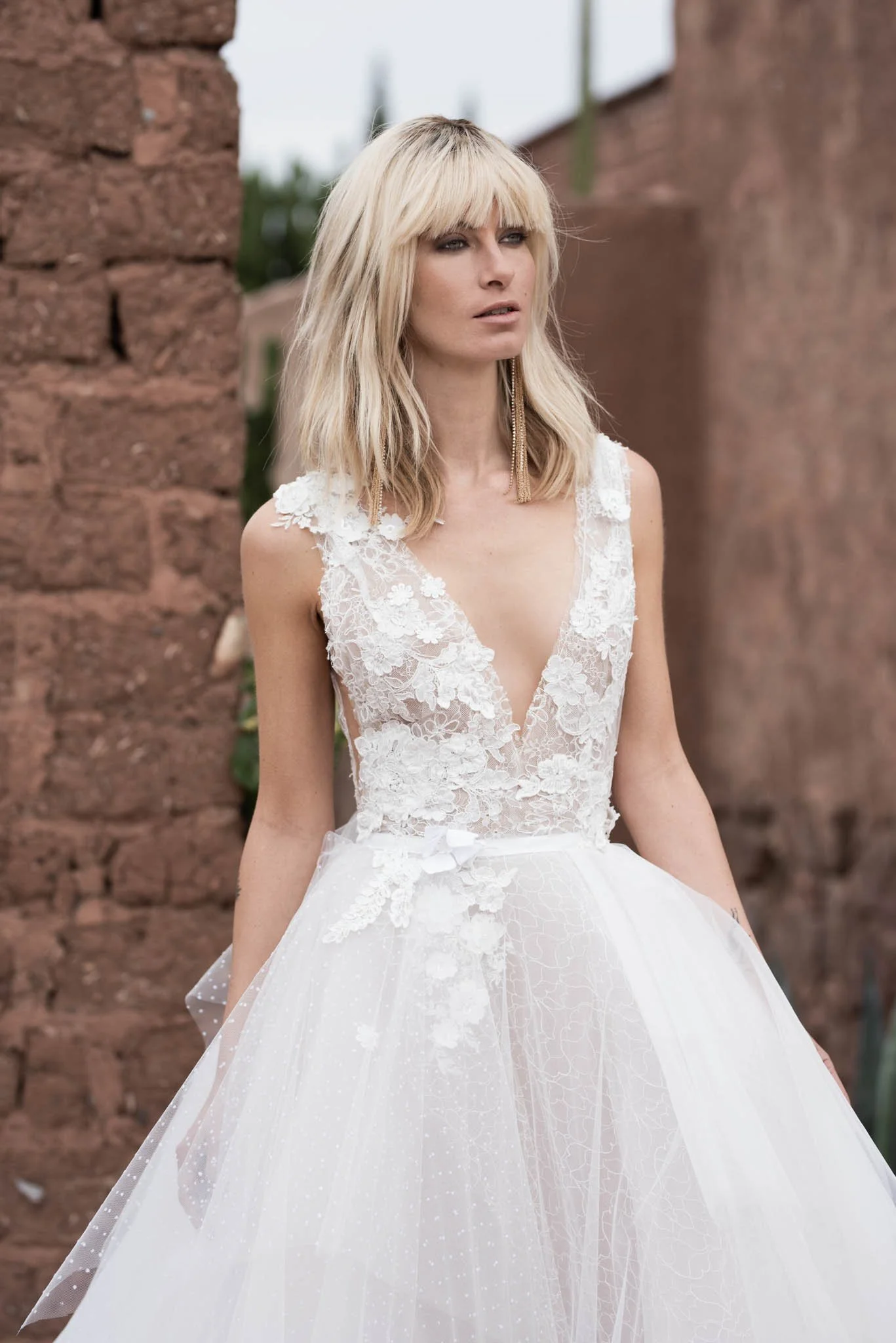 Model wears a tulle ball gown with V neckline in lace and hand sewn lace accents "Robin" by Atelier Edwin Oudshoorn