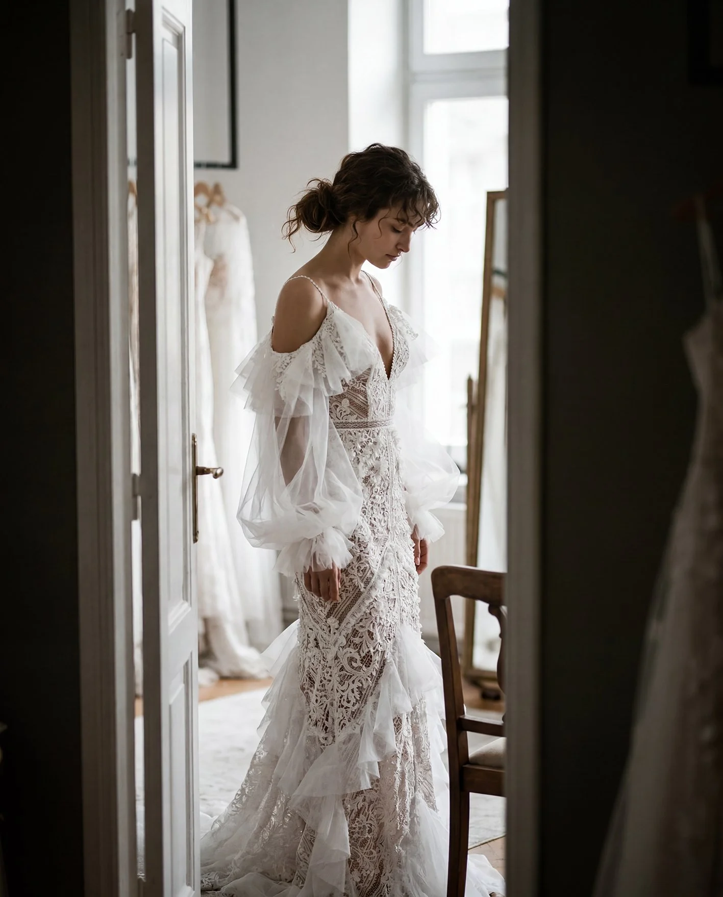 Rich lace, hand applied lace accents and waves of silk organza.

&lsquo;Ivy&rsquo; from our Atelier collection NOMADS.

Hand crafted in our own atelier and sculpted to your measurements.