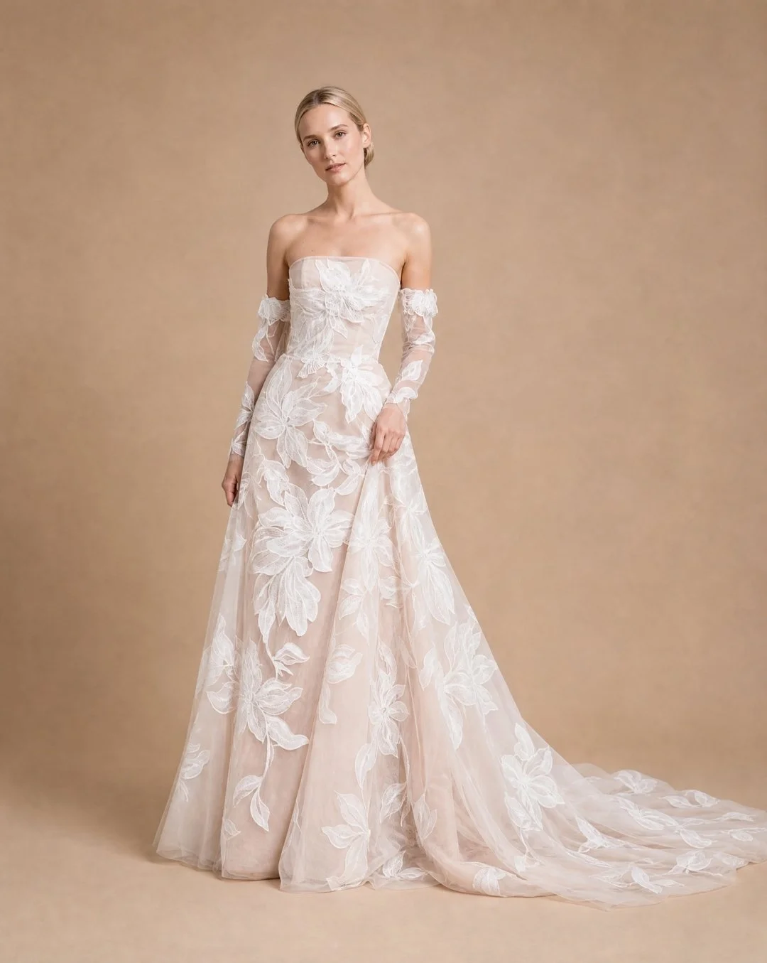 Large scaled floral embroidery with subtle sequins for an added delicate sparkle. ​​​​​​​​
​​​​​​​​
Layered over soft hued tulles to add softness and movement. ​​​​​​​​
​​​​​​​​
Robin wears &lsquo;Paige&rsquo;.