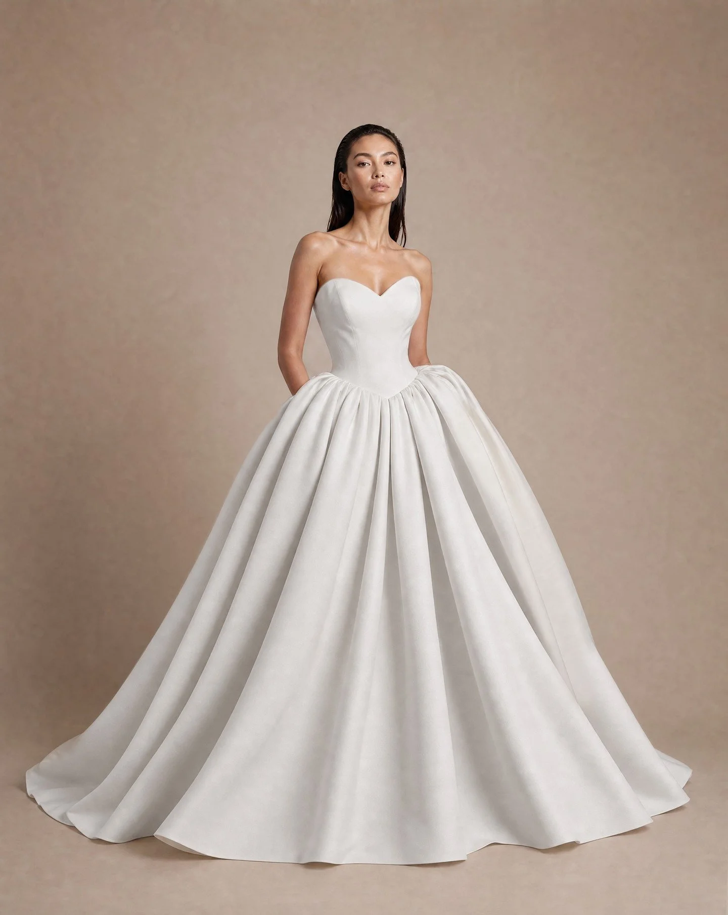 Dramatic ballgown from the SS27 Nicole and Felicia couture collection.

NF154-1 is crafted in a soft matt Mikado fabric with a structured sweetheart corset bodice with dropped basque waist.
The skirt is Dramatic with a capital D and adds huge wow fac