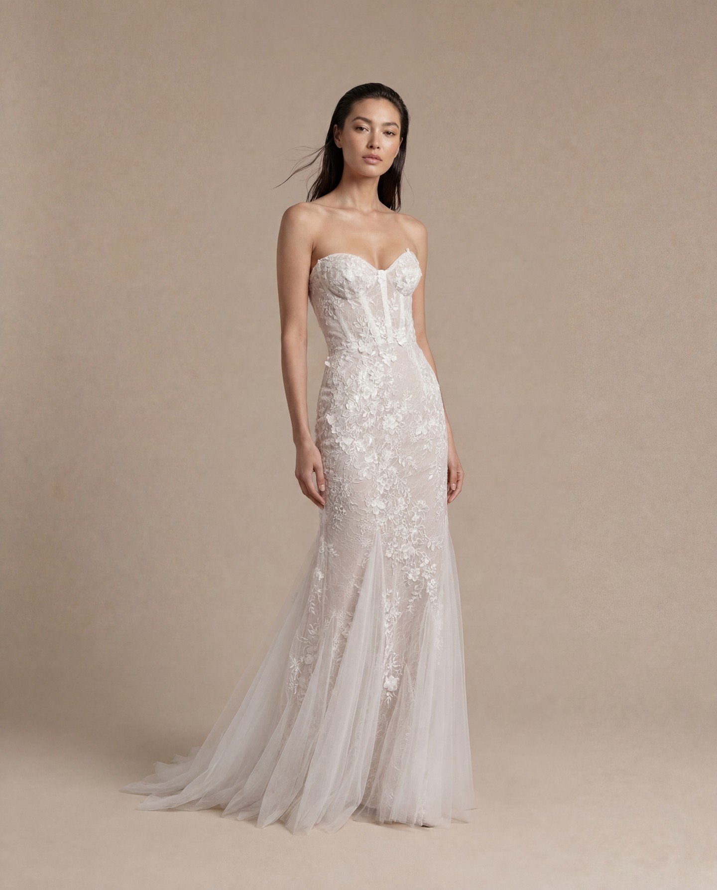 Floral embroidery on a soft tulle column wedding gown, with delicate tulle inlays creating a gentle fit and flare....

'Siren' has a structured corset top and visible boning.