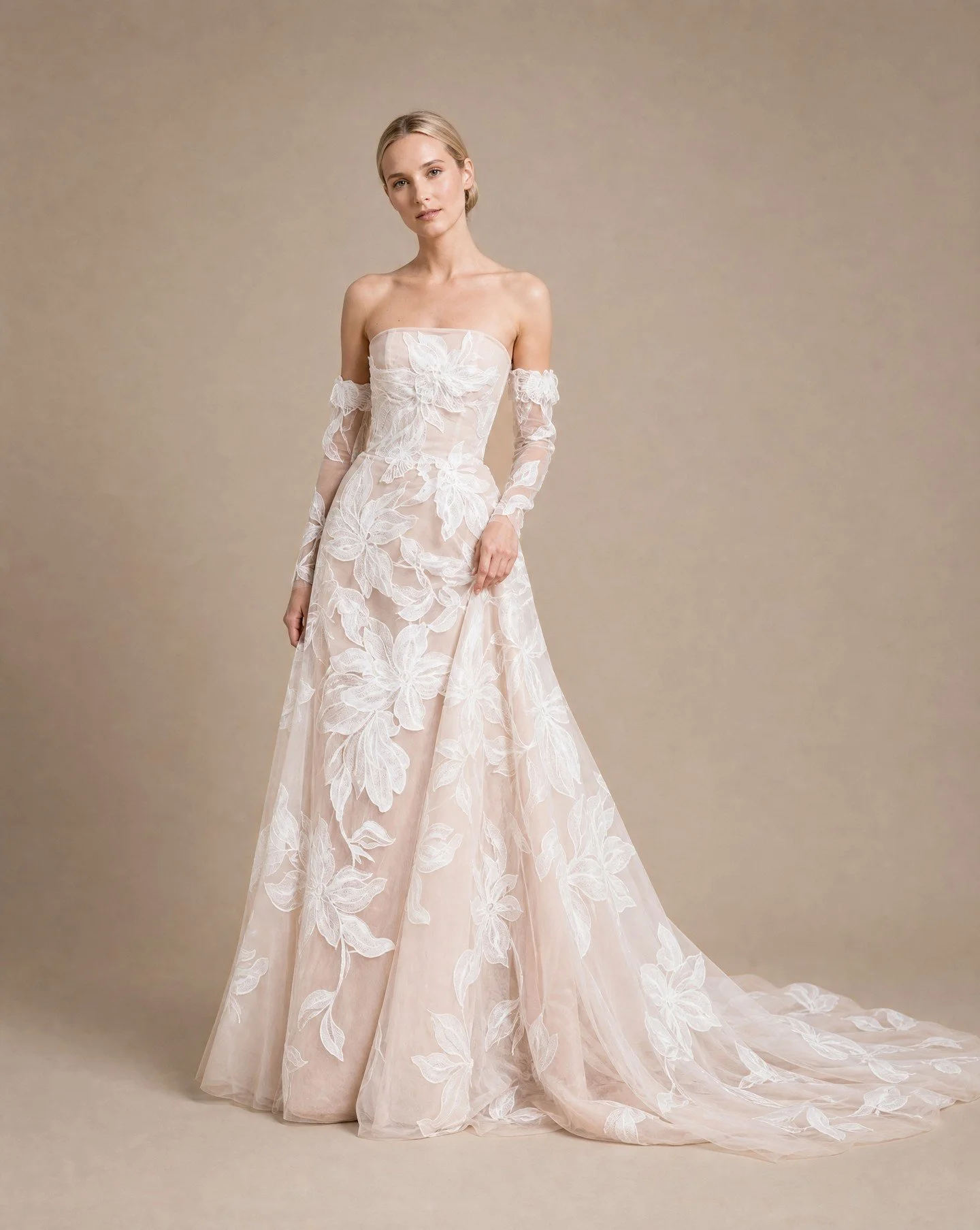 Soft blush tones and graphic florals.

A lightweight A-Line gown with layers of delicate tulle and a structured hand crafted corset.

'Paige' remains a classic within our bridal collection.