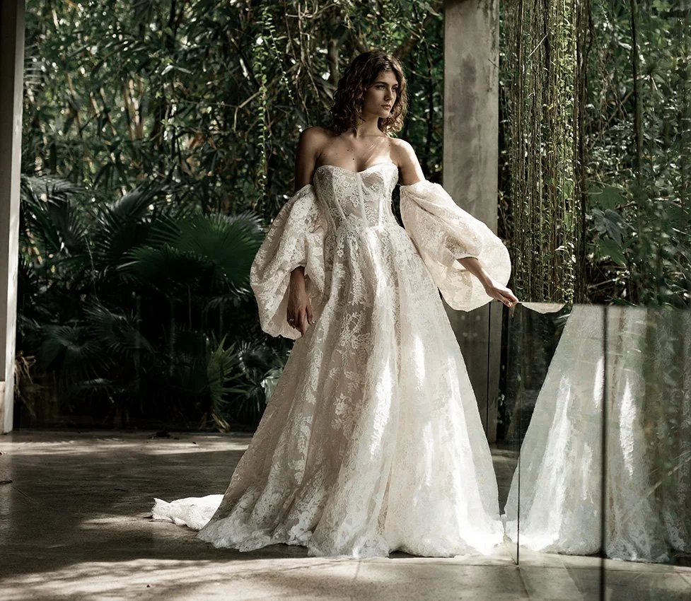 Woman wering full lace ballgown wedding dress with large puff sleeves "Hannah" by Ateiier Edwin Oudshoorn