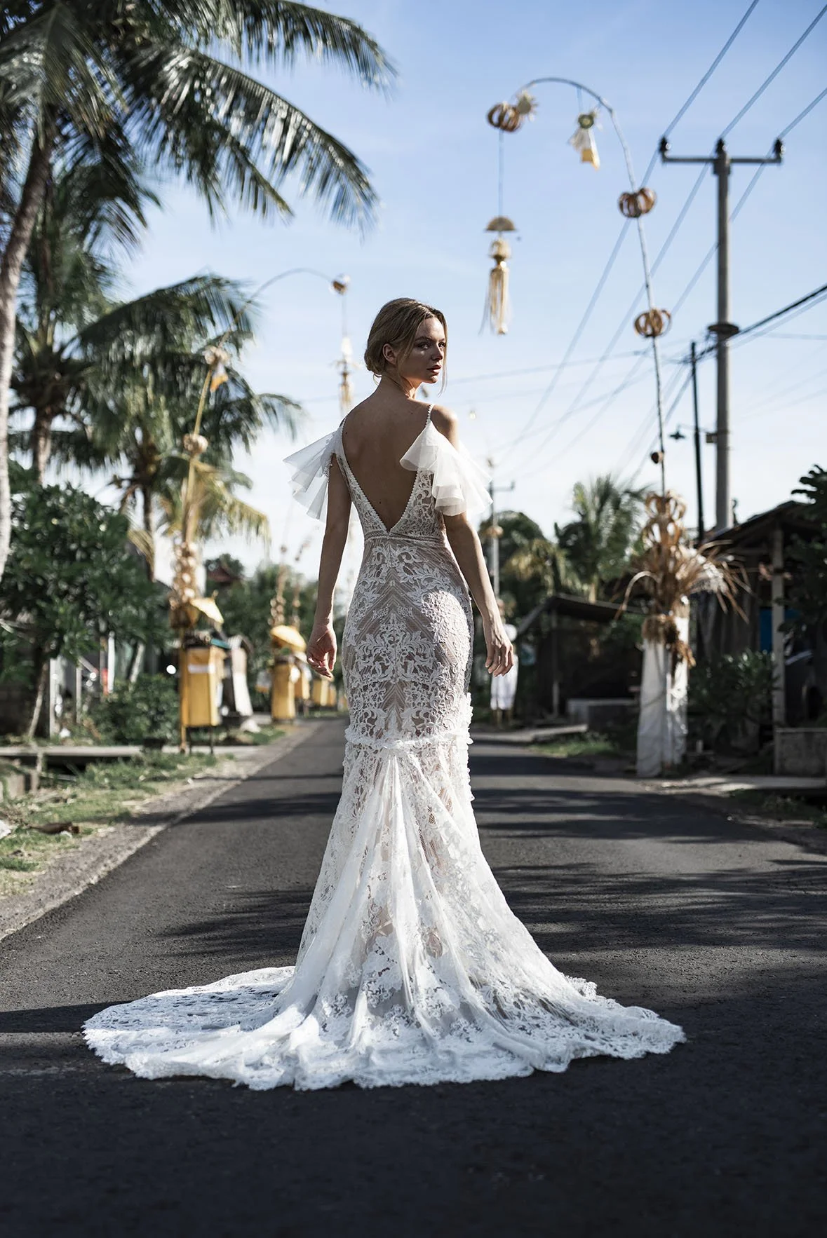 Woman wearing a full lace fit and flare wedding dress "Mia" by Atelier Edwin Oudshoorn