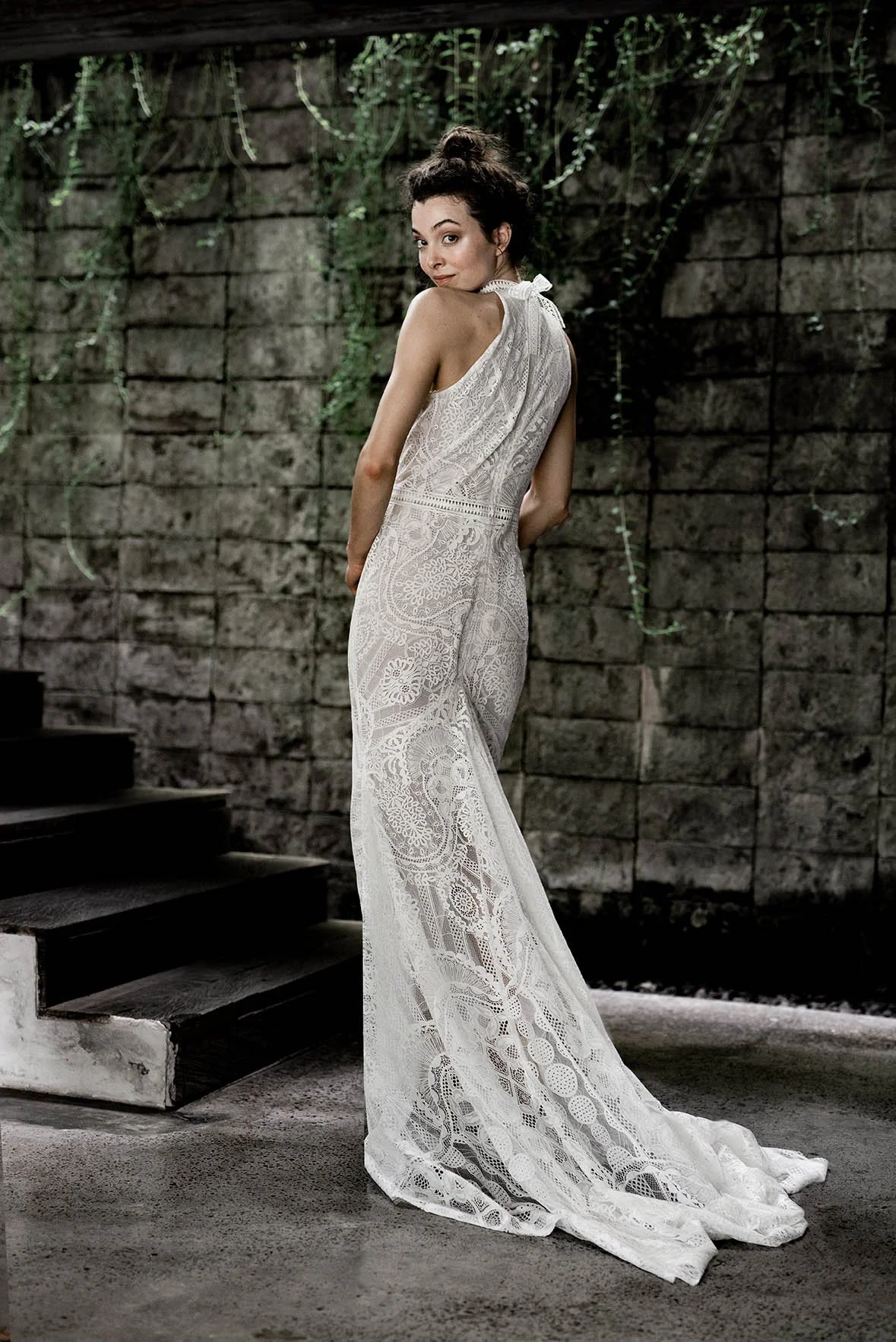 Woman wearing a lace fishtail wedding gown with halter neckline "Willow" by Atelier Edwin Oudshoorn