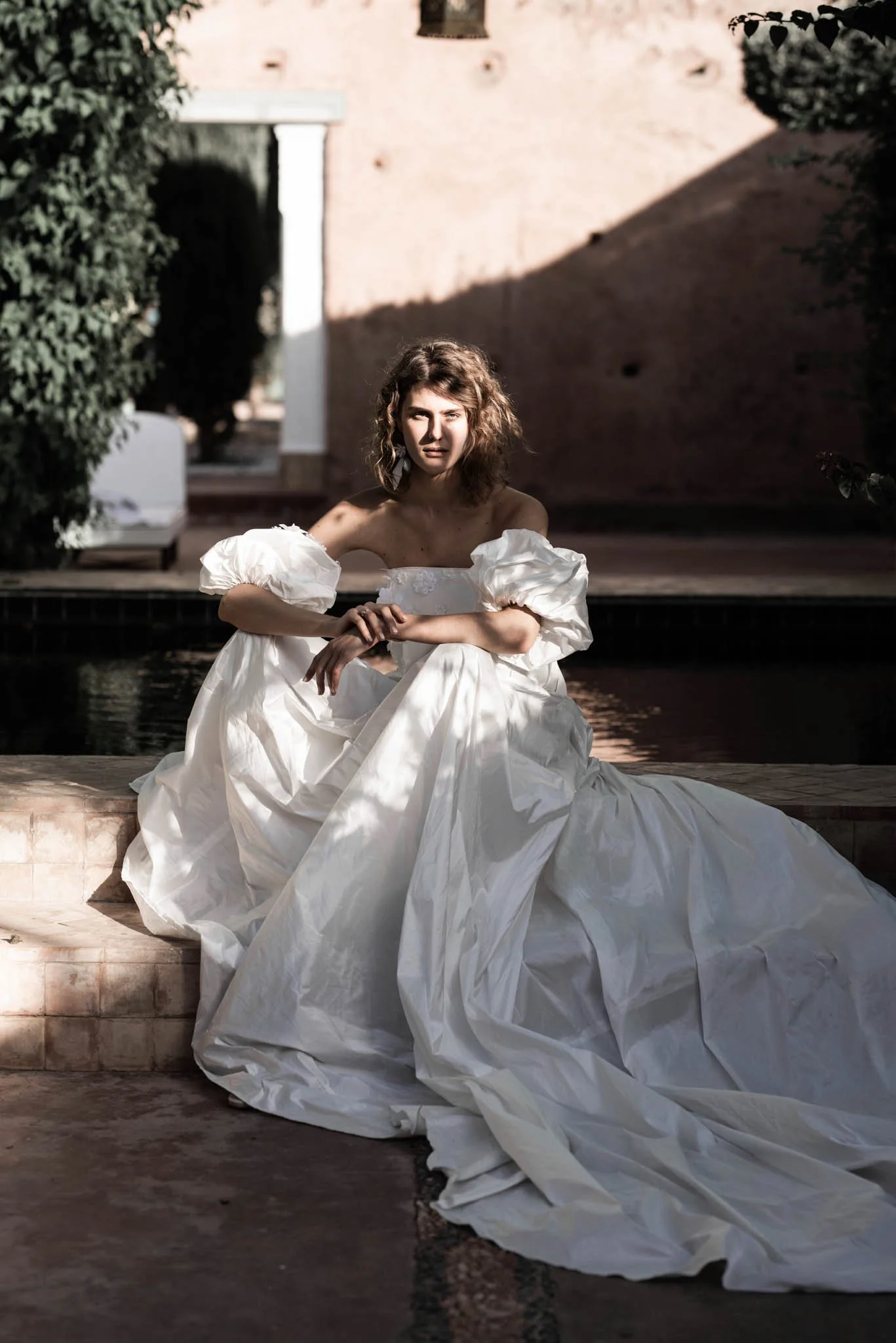 Bride wears a silk taffeta wedding gown with exaggerated bell form and puff sleeved "Scarlett" by Atelier Edwin Oudshoorn