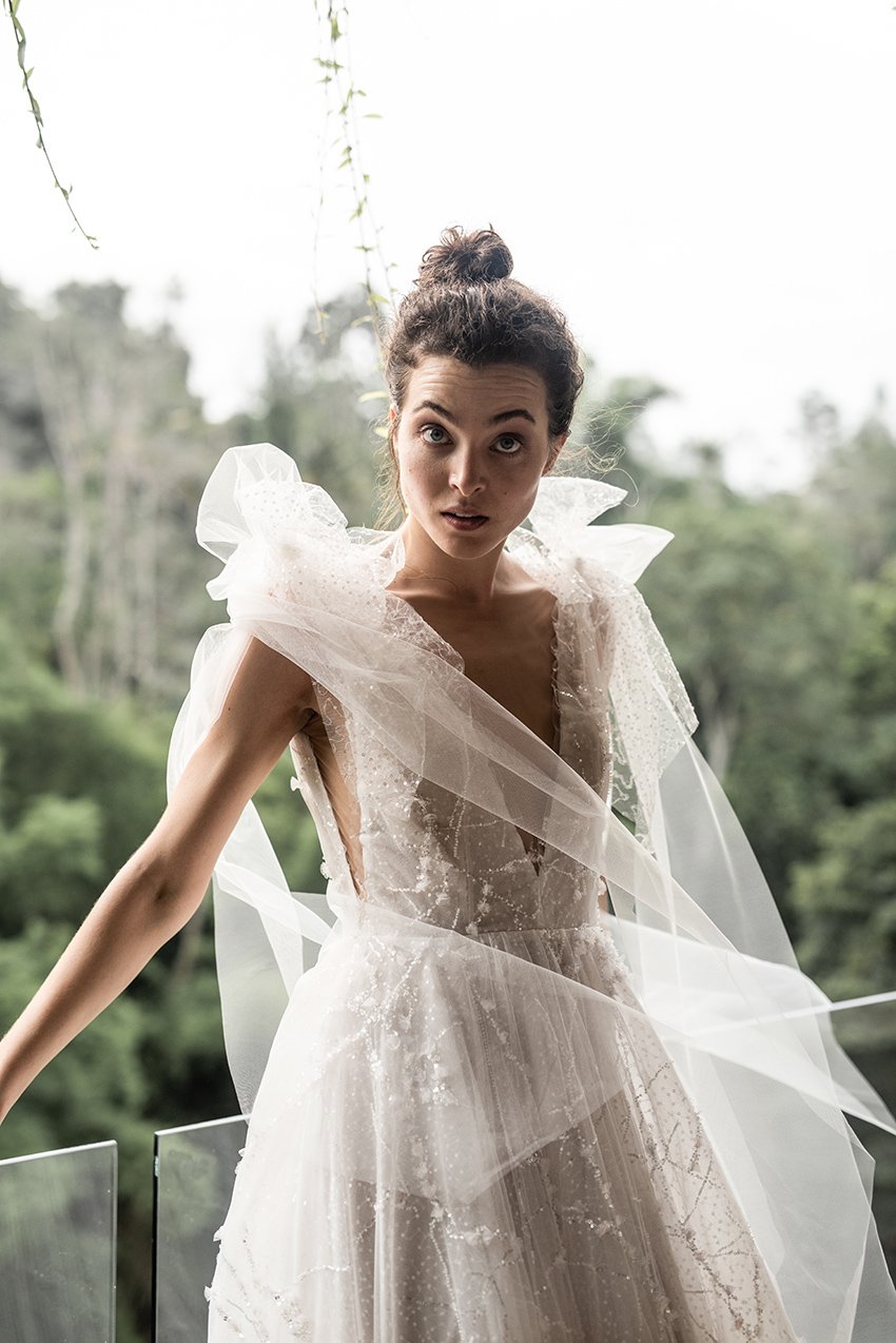 Woman wearing embroidered tulle ballgown with removable bows "Stellar" by Atelier Edwin Oudshoorn