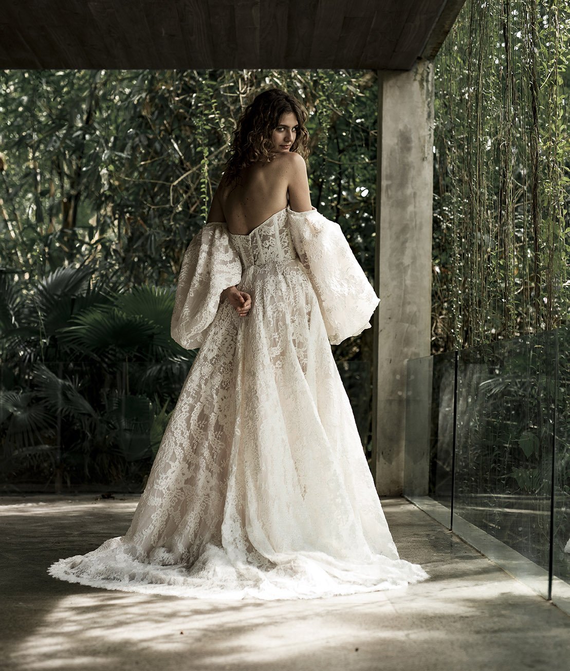 Woman wering full lace ballgown wedding dress with large puff sleeves "Hannah" by Ateiier Edwin Oudshoorn