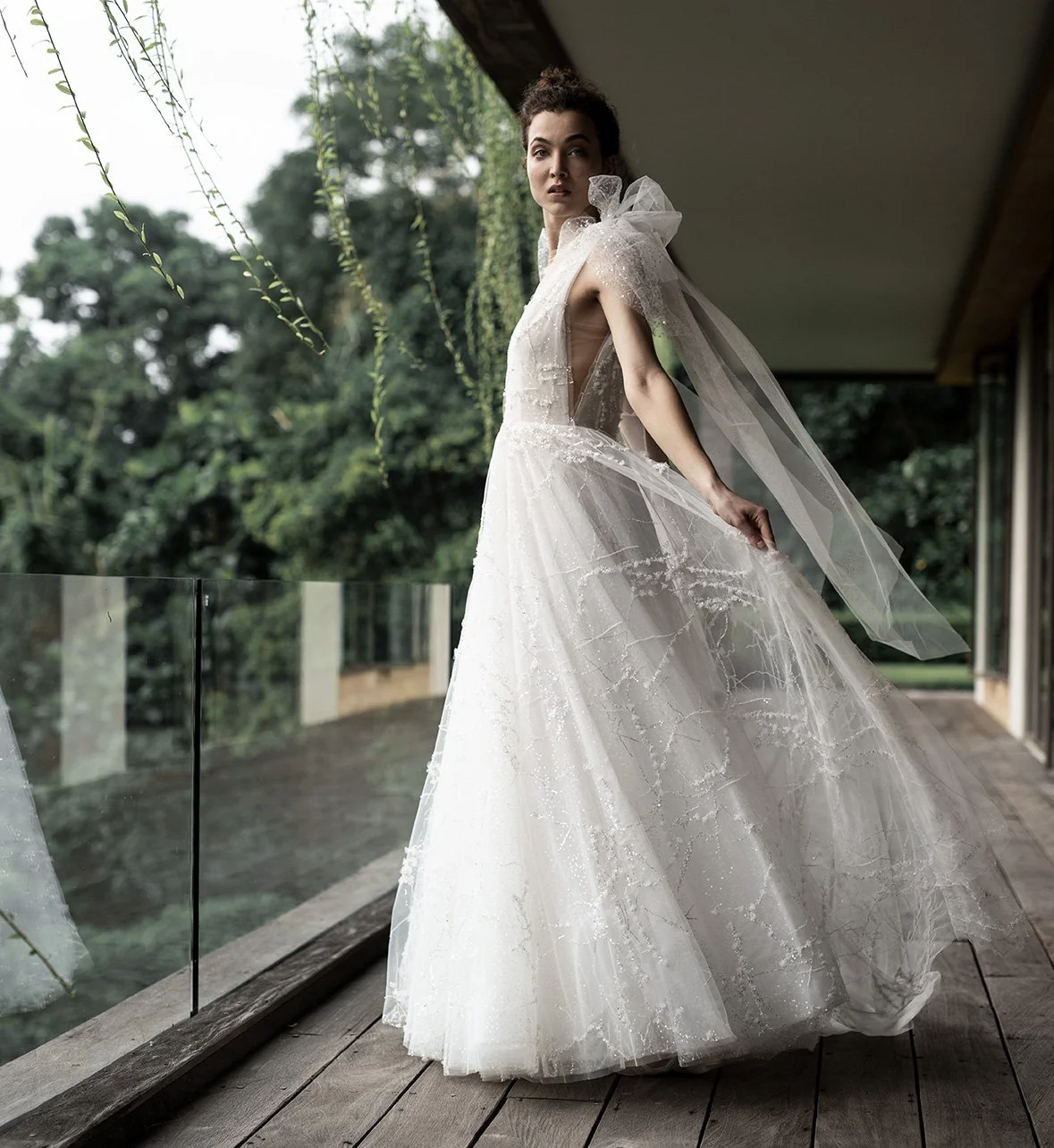 Woman wearing embroidered tulle ballgown with removable bows "Stellar" by Atelier Edwin Oudshoorn