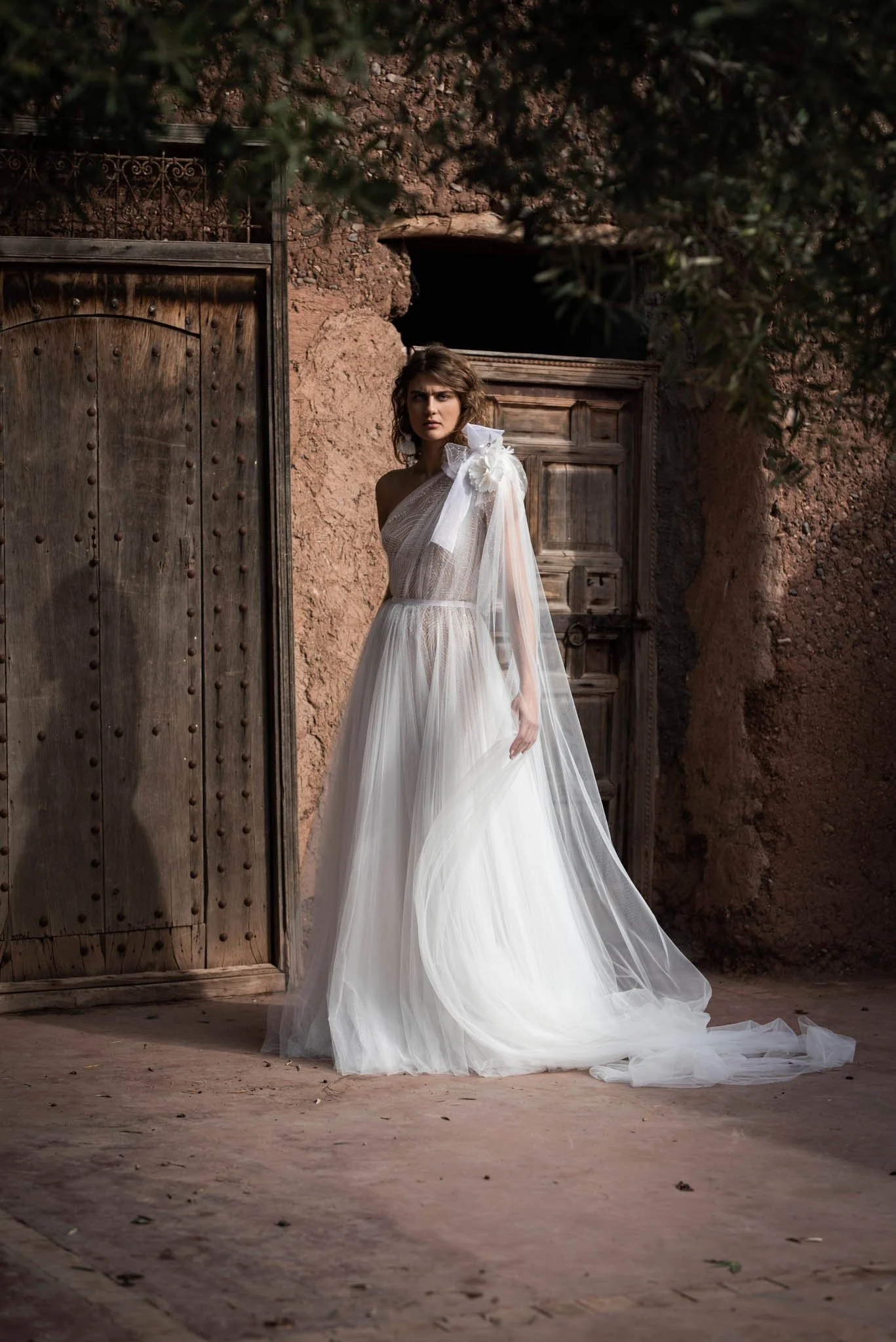 Bride wears a wedding dress by Edwin Oudshoorn, made from layers of tulle and silk "Audrey"