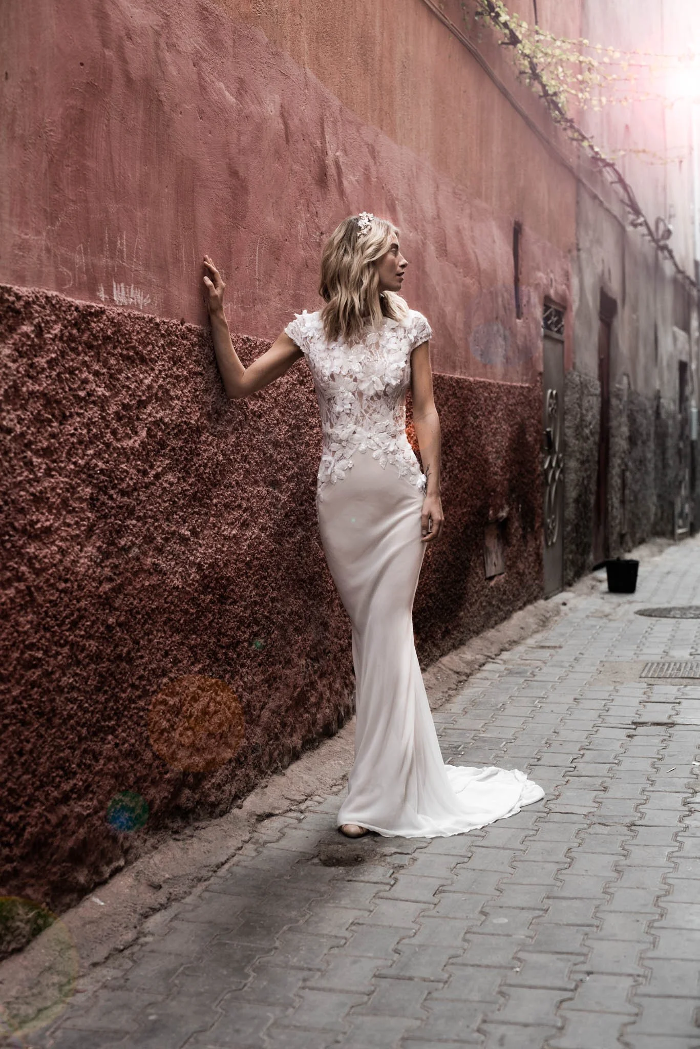 Bride wears delicate silk wedding dress with hand embroidered lace details "Lotte" by Atelier Edwin Oudshoorn