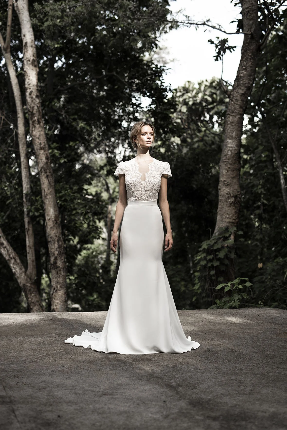 Woman wears white crepe wedding dress with lace top with short sleeves "Quinn" by Atelier Atelier Edwin Oudshoorn