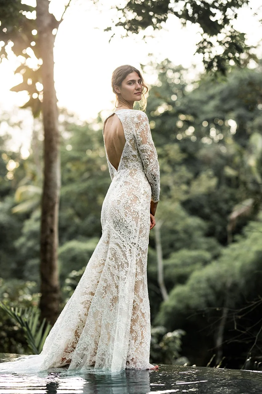 Woman wearing full lace wedding dress with long sleeves "Harper" by Edwin Oudshoorn
