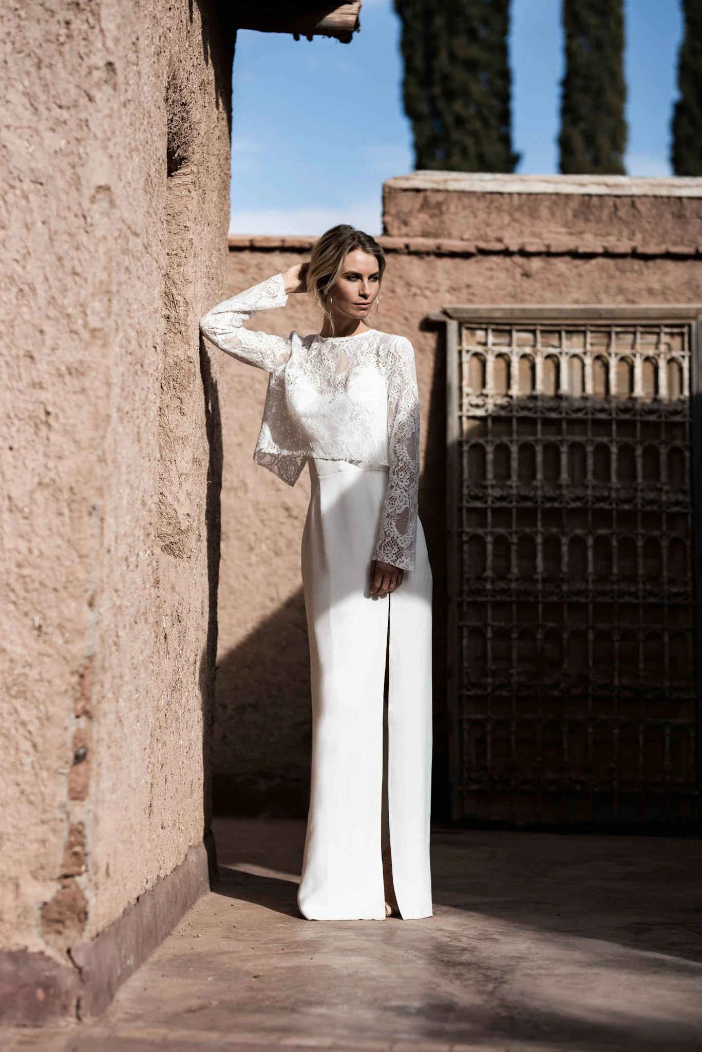 Bride wears ivory slip dress with a Lace top with long sleeves and open back in marrakech