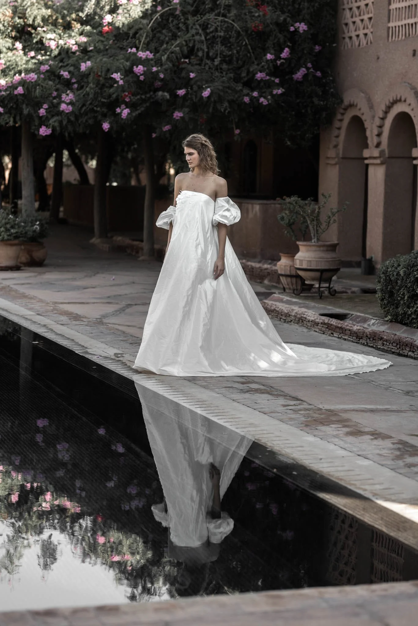 Bride wears a silk taffeta wedding gown with exaggerated bell form and puff sleeved "Scarlett" by Atelier Edwin Oudshoorn