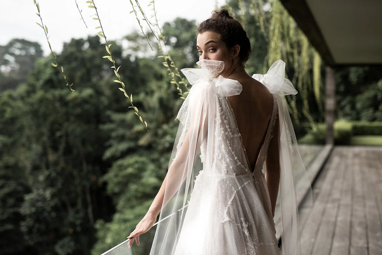 Woman wearing embroidered tulle ballgown with removable bows "Stellar" by Atelier Edwin Oudshoorn